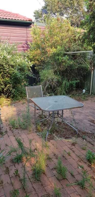 Home Backyard Dirty Garden With Table And Chairs — Saving Time In Lake Macquarie NSW