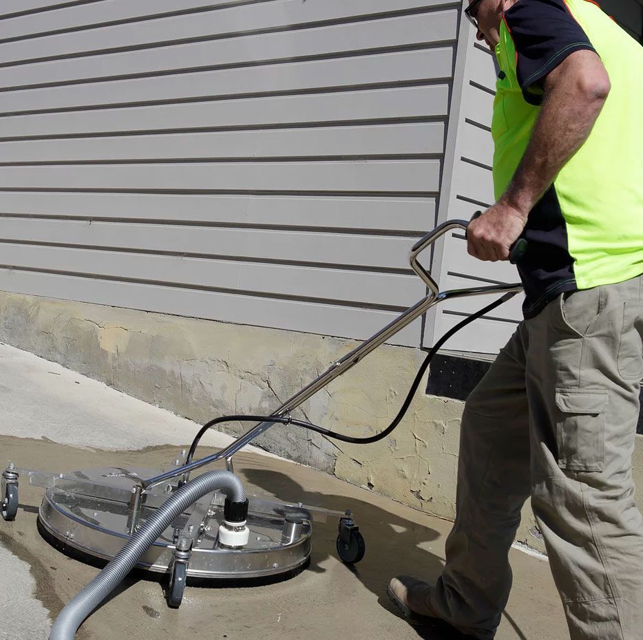Worker Washing The Concrete Driveway — Saving Time In Charlestown NSW