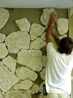 Contractor installing stone onto the wall