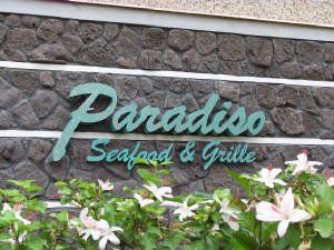 Stone wall with installed paradise signage