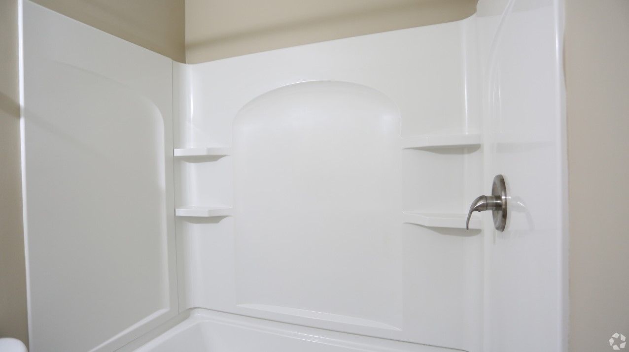 A bathroom with a white shower stall and a bathtub.