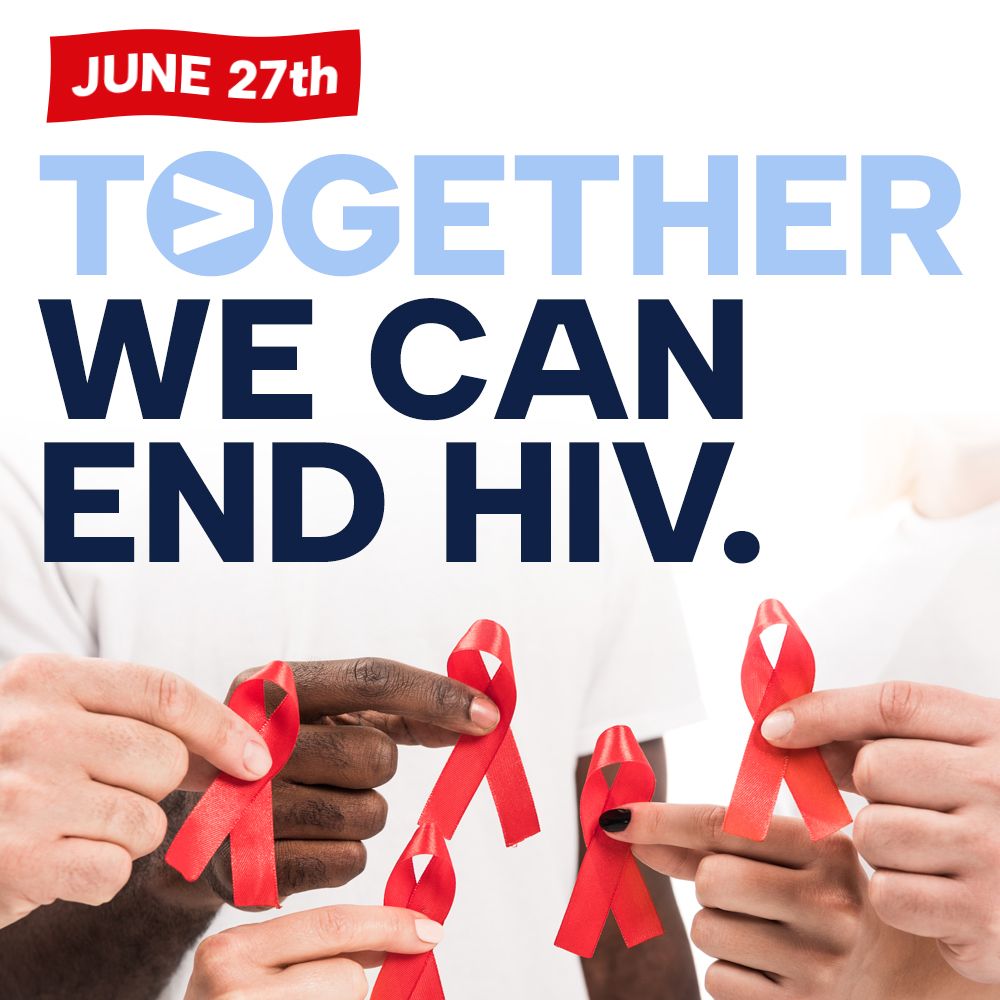 A red ribbon is on a white background for national hiv testing day.