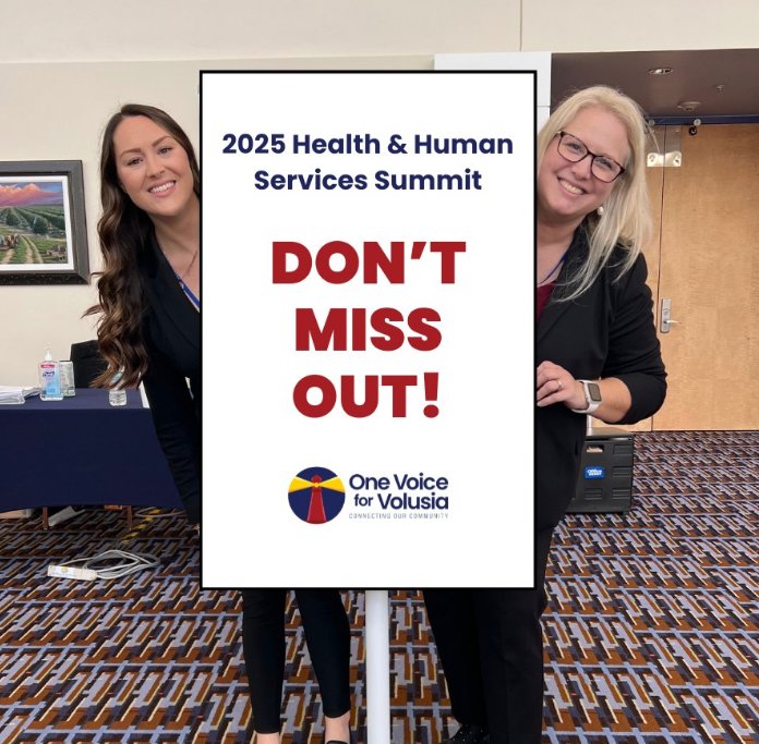 Two women standing next to a sign that says do n't miss out