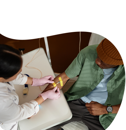 A woman is giving a man an injection in his arm