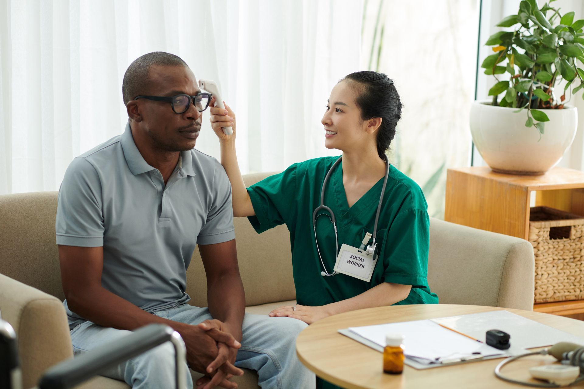 A nurse is taking a patient 's temperature with a thermometer.