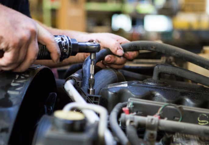 A mechanic working on a vehicle | Maywood Automotive
