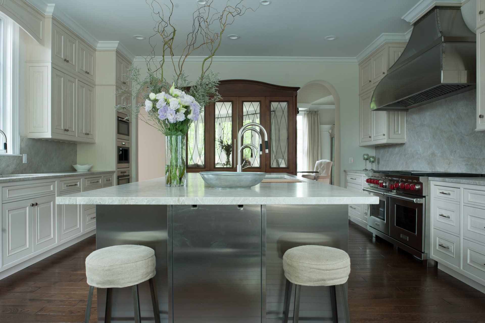 A kitchen with white cabinets and stainless steel appliances