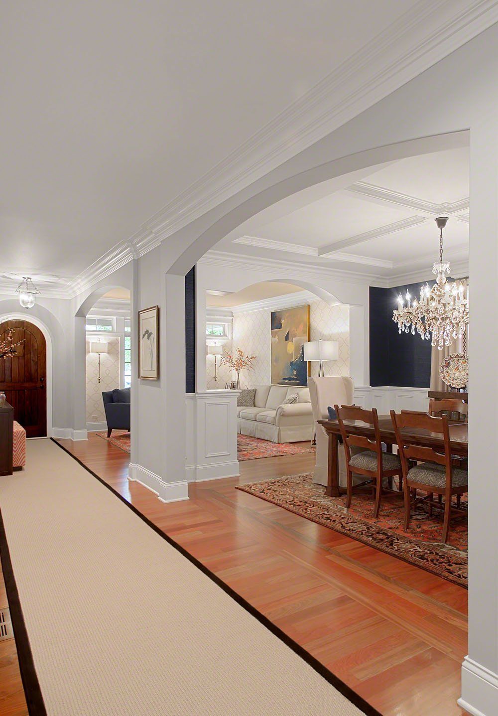 A long hallway leading to a living room and dining room