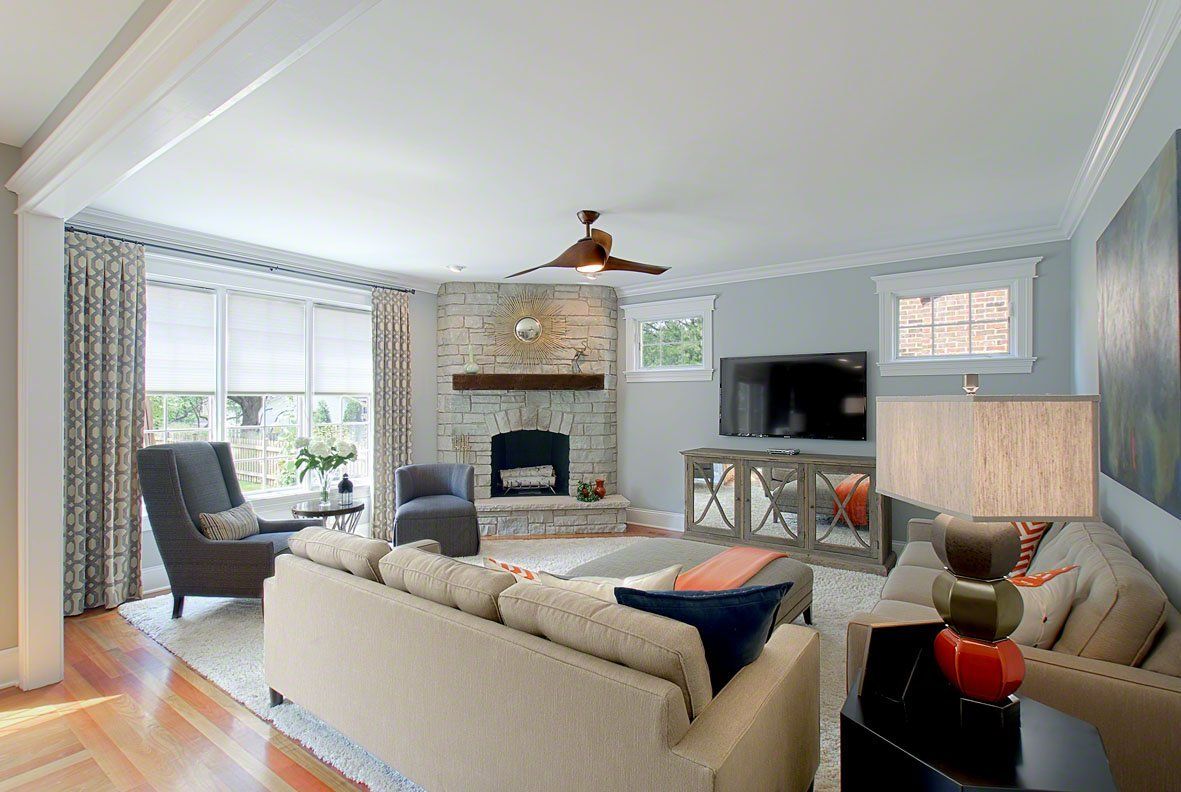 A living room filled with furniture and a fireplace.