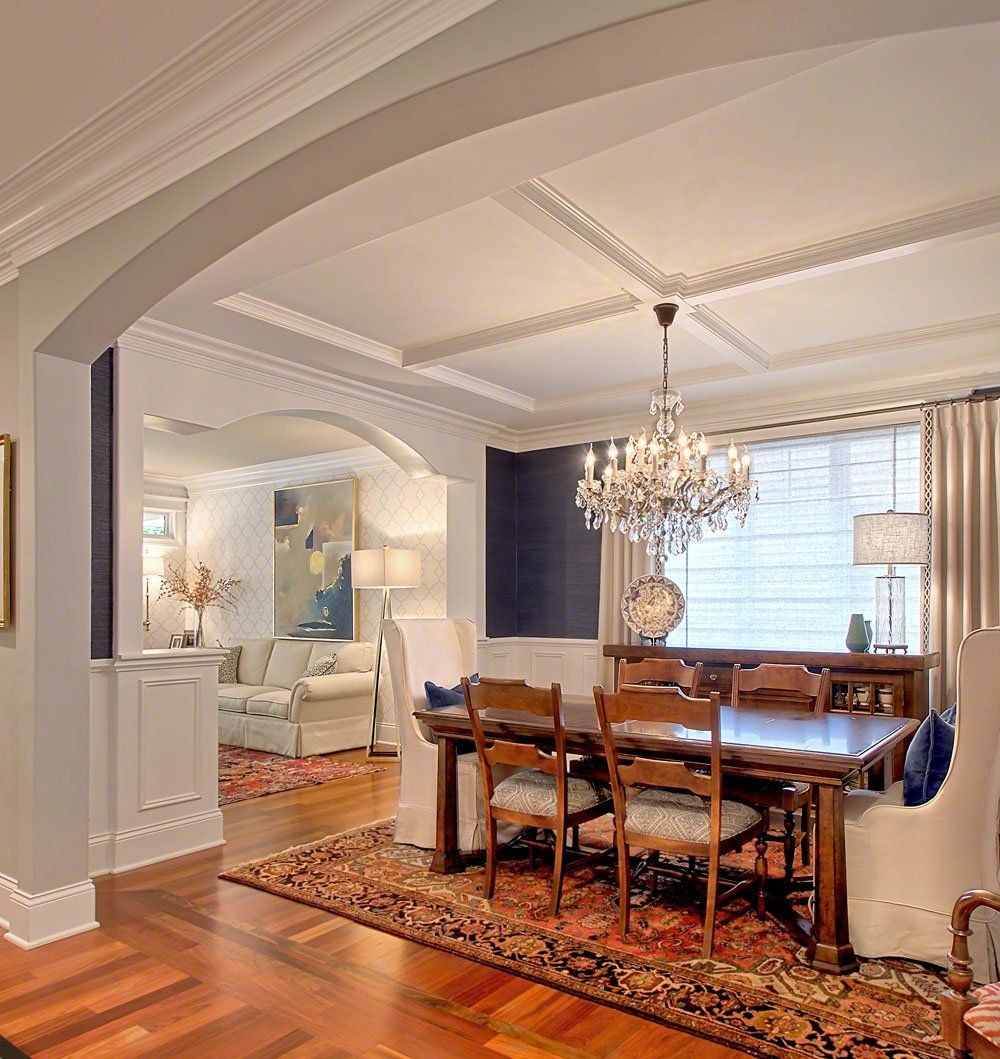 A dining room with a table and chairs and a chandelier