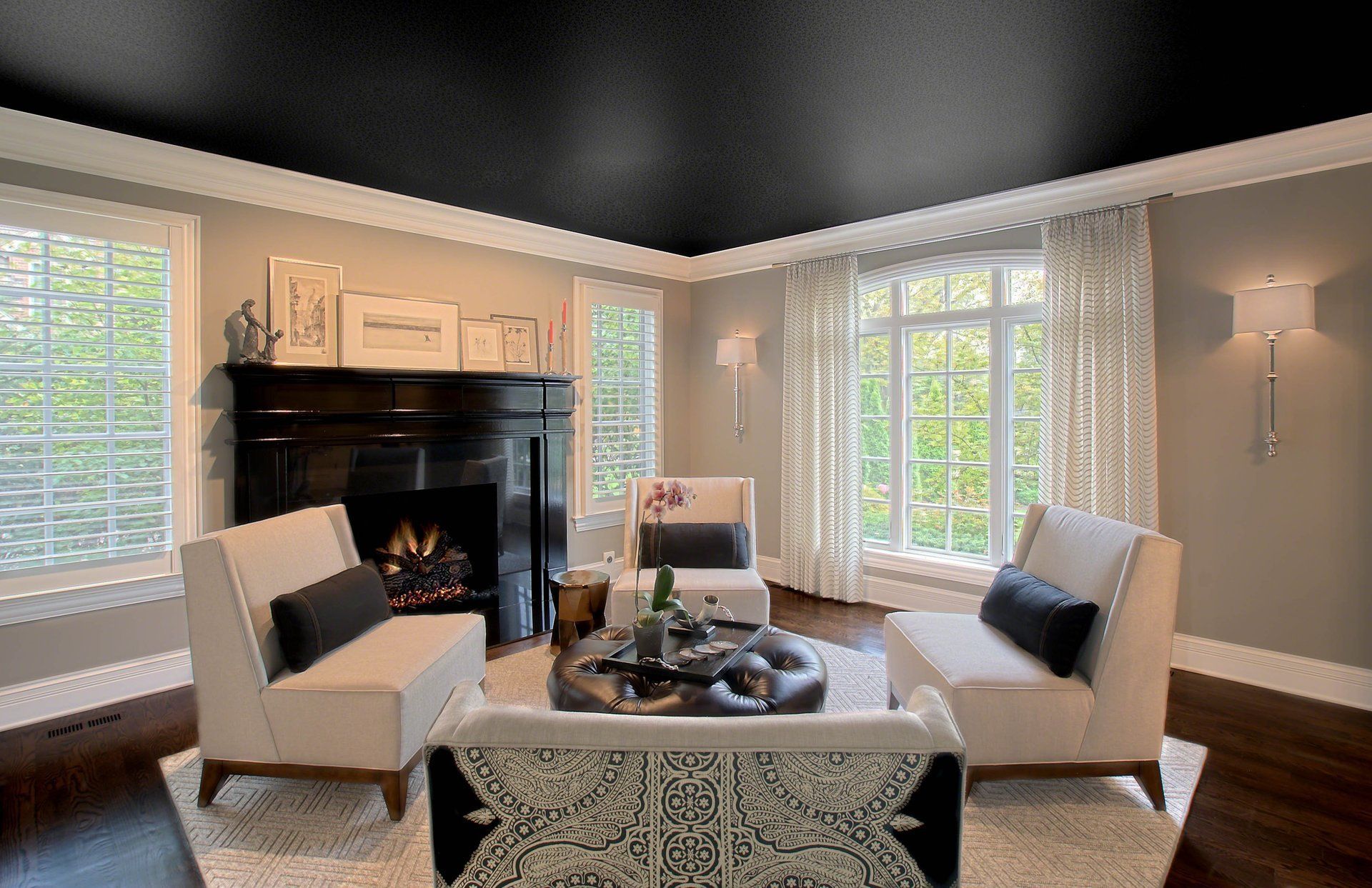 A living room with a black ceiling and a fireplace