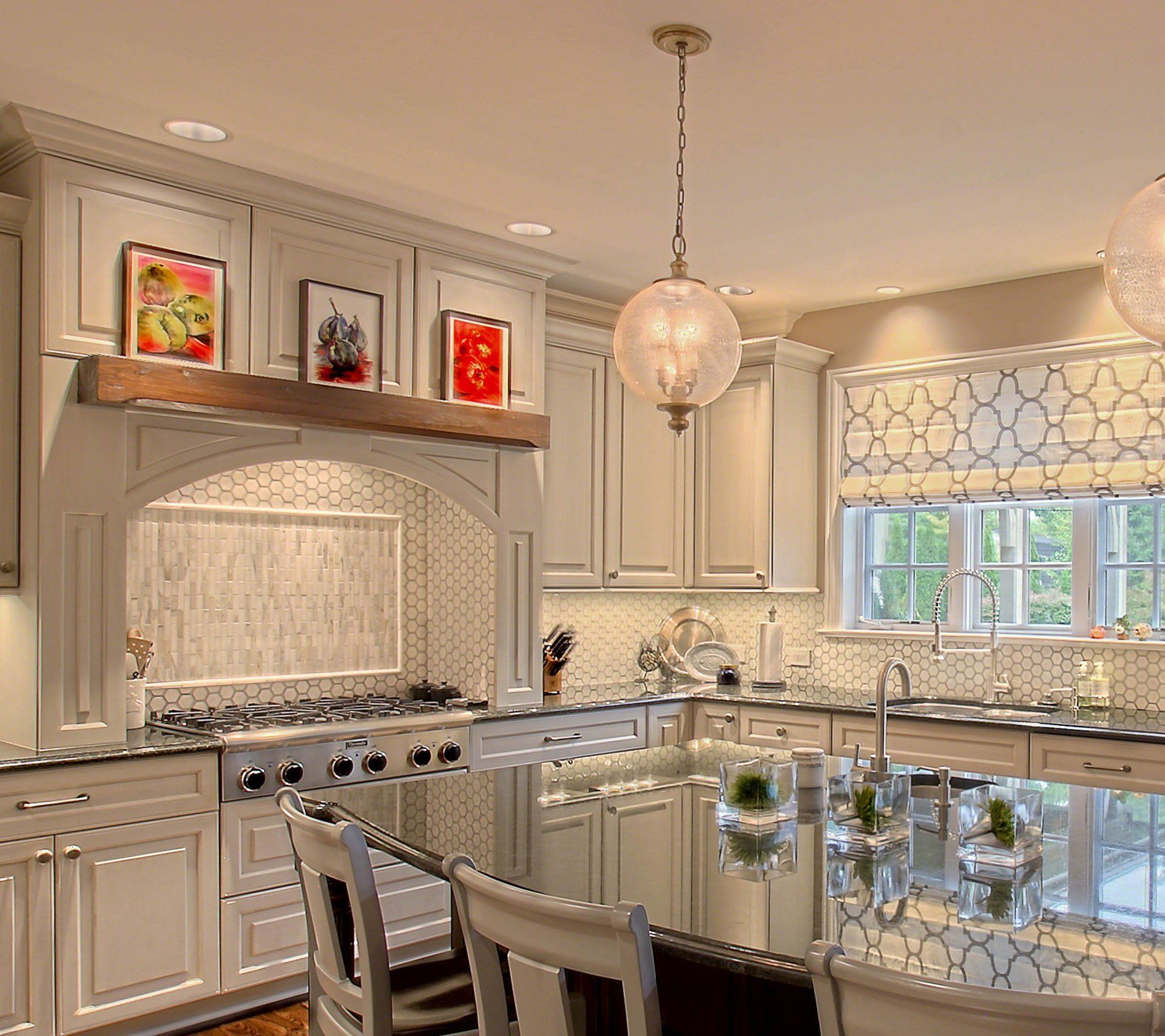 A kitchen with white cabinets and a large island