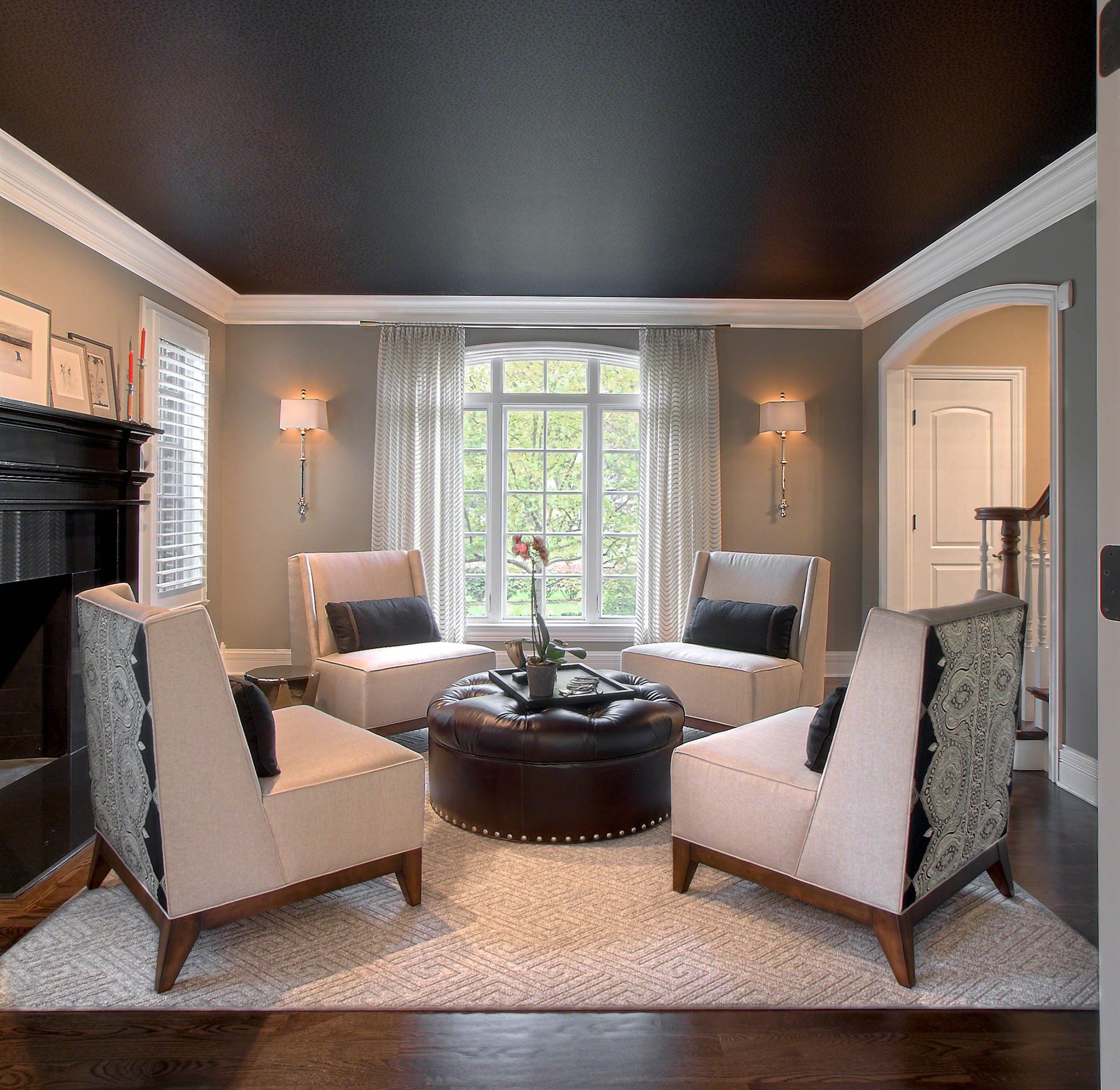 A living room with a black ceiling and white furniture