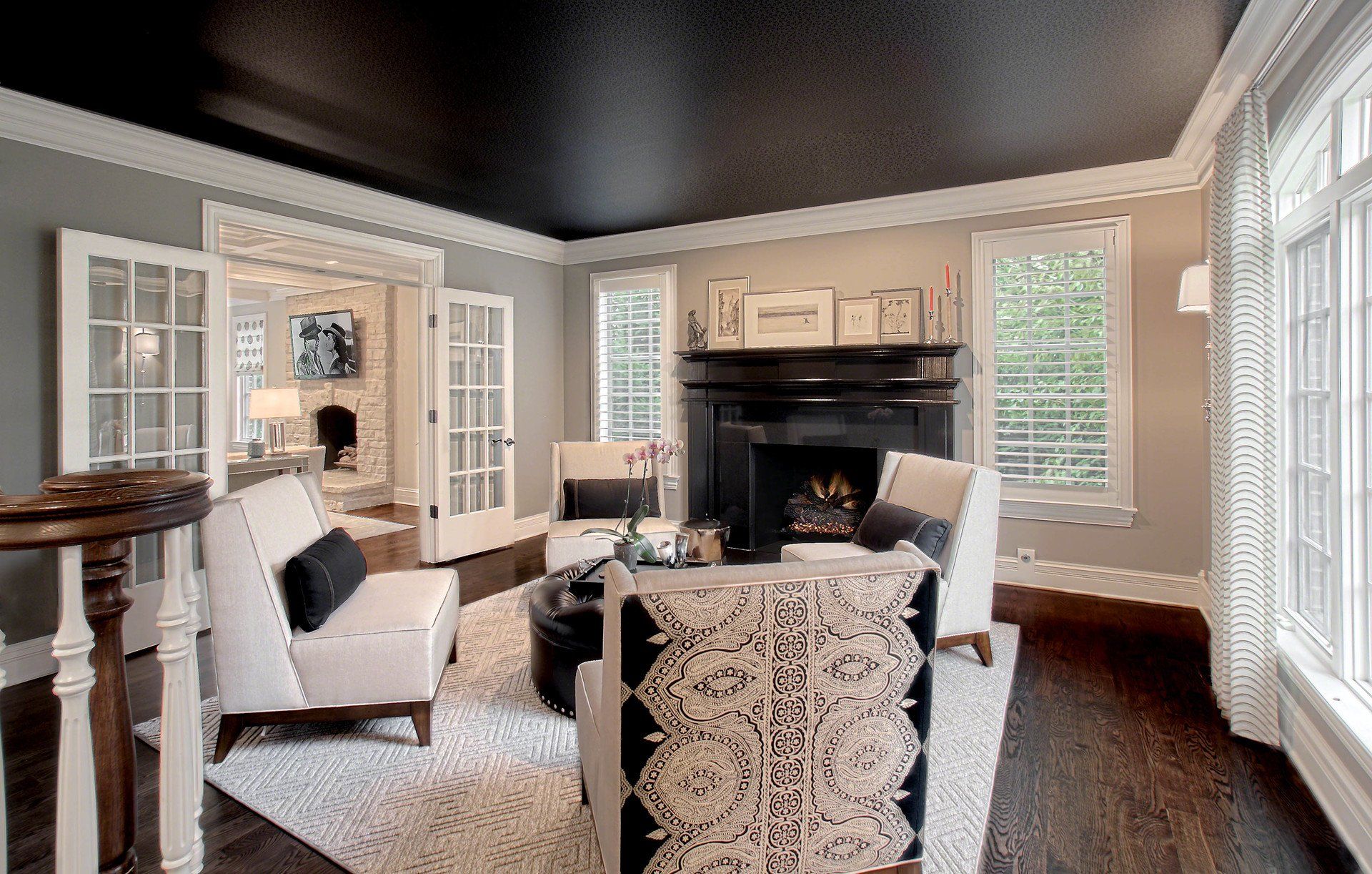 A living room with a black ceiling and a fireplace.
