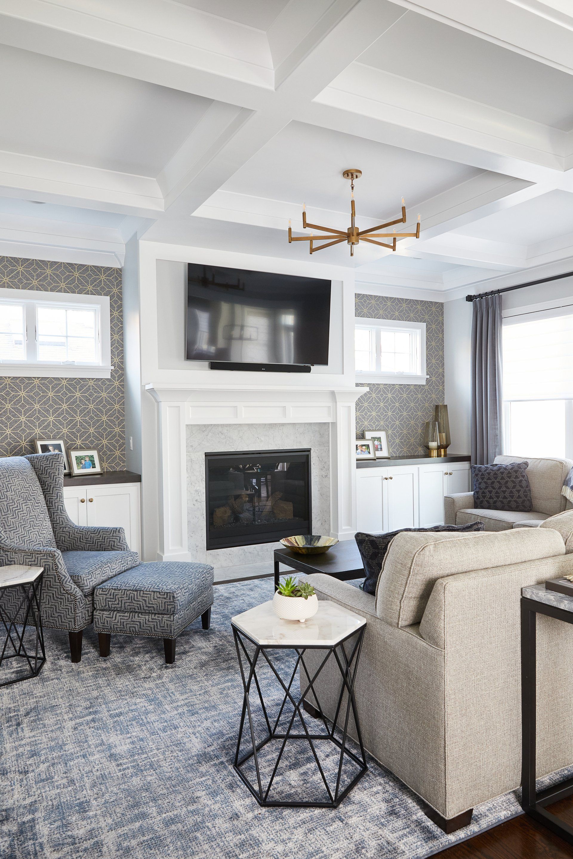 A living room with a fireplace and a flat screen tv.