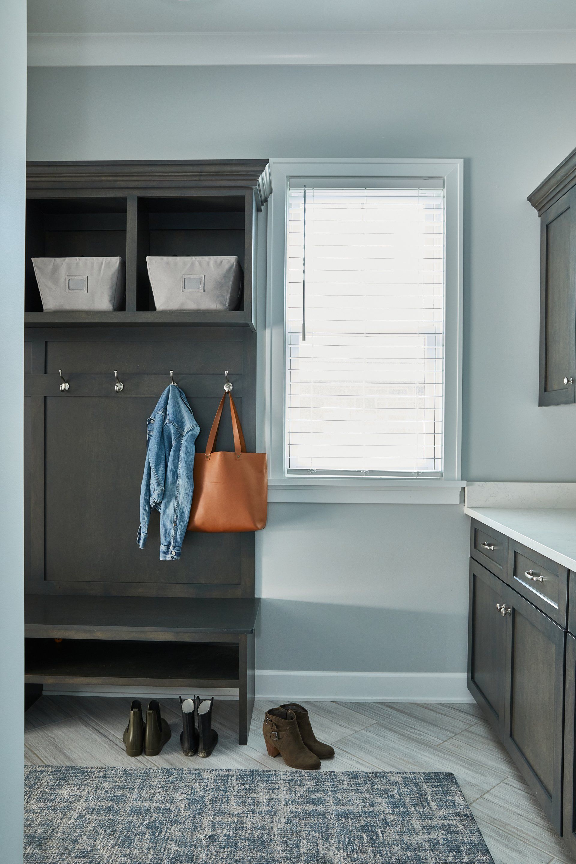 A laundry room with a bench and a window.