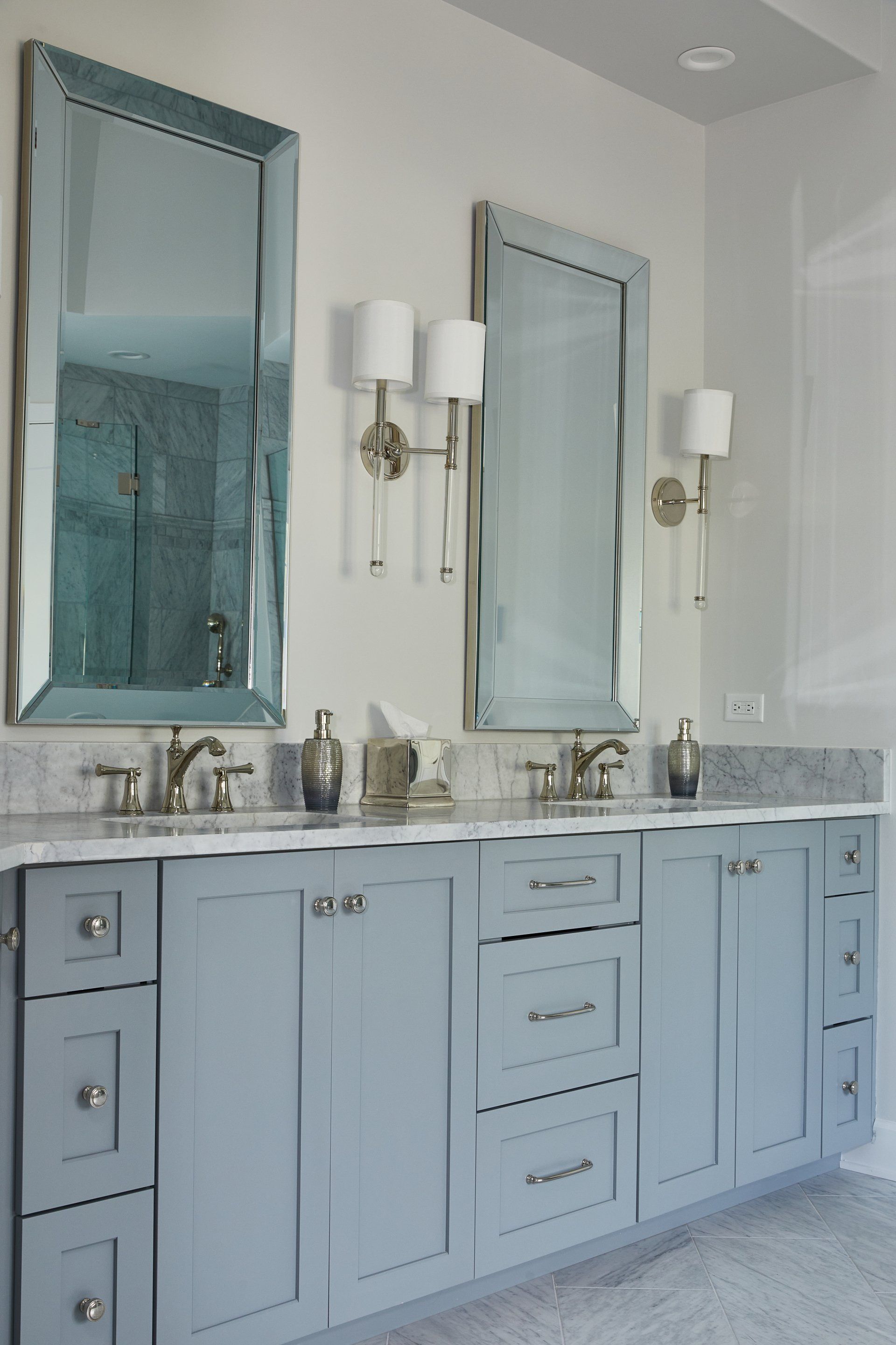 A bathroom with two sinks and two mirrors