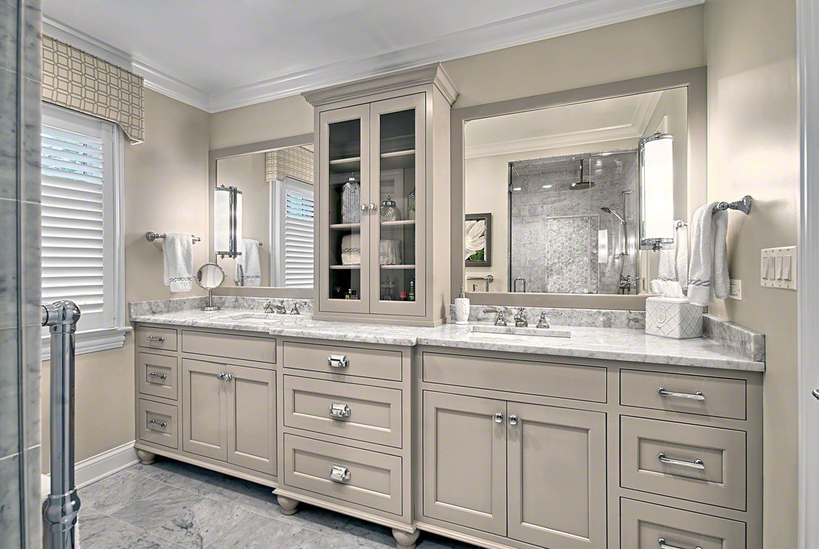 A bathroom with two sinks and two mirrors.
