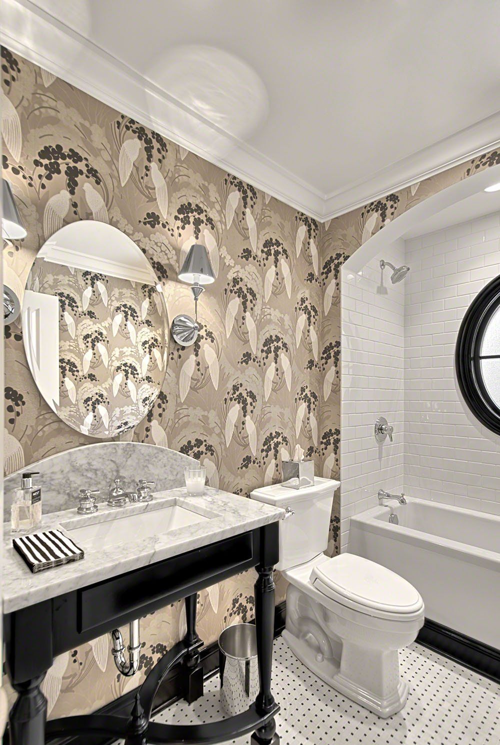 A bathroom with a sink , toilet , tub and mirror.