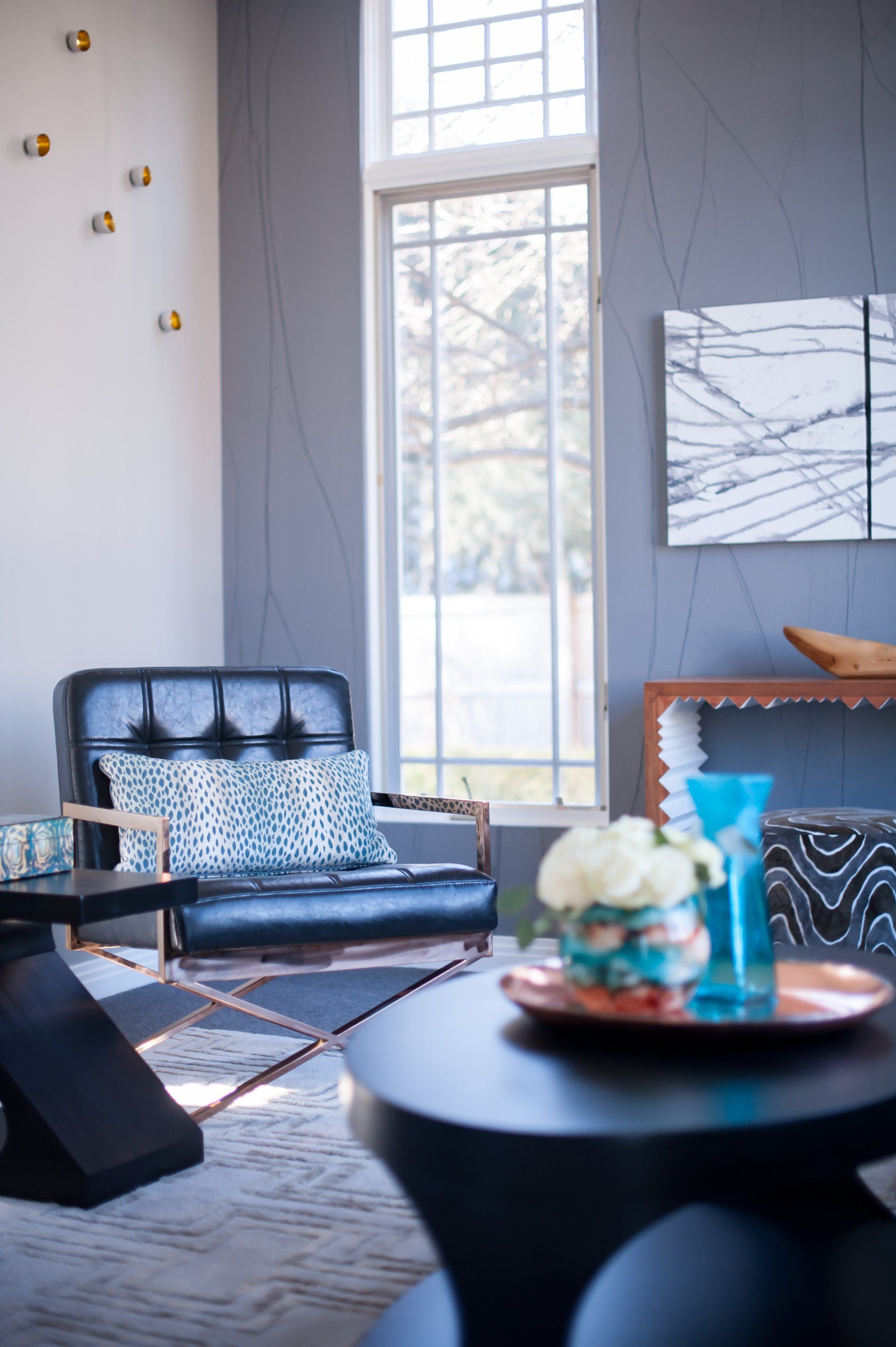 A living room with a blue couch and a black table