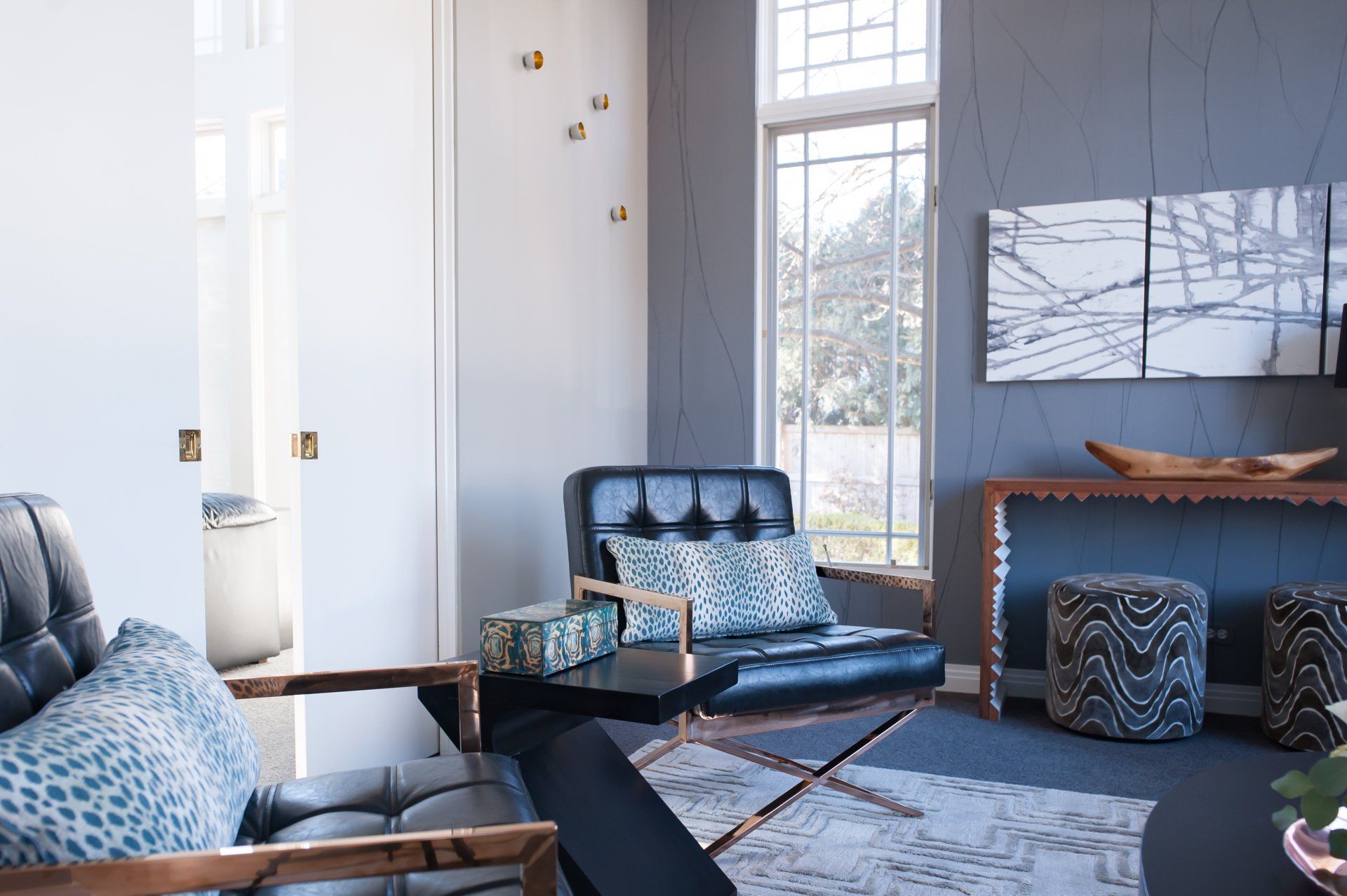 A living room with a couch , chairs , and a table.