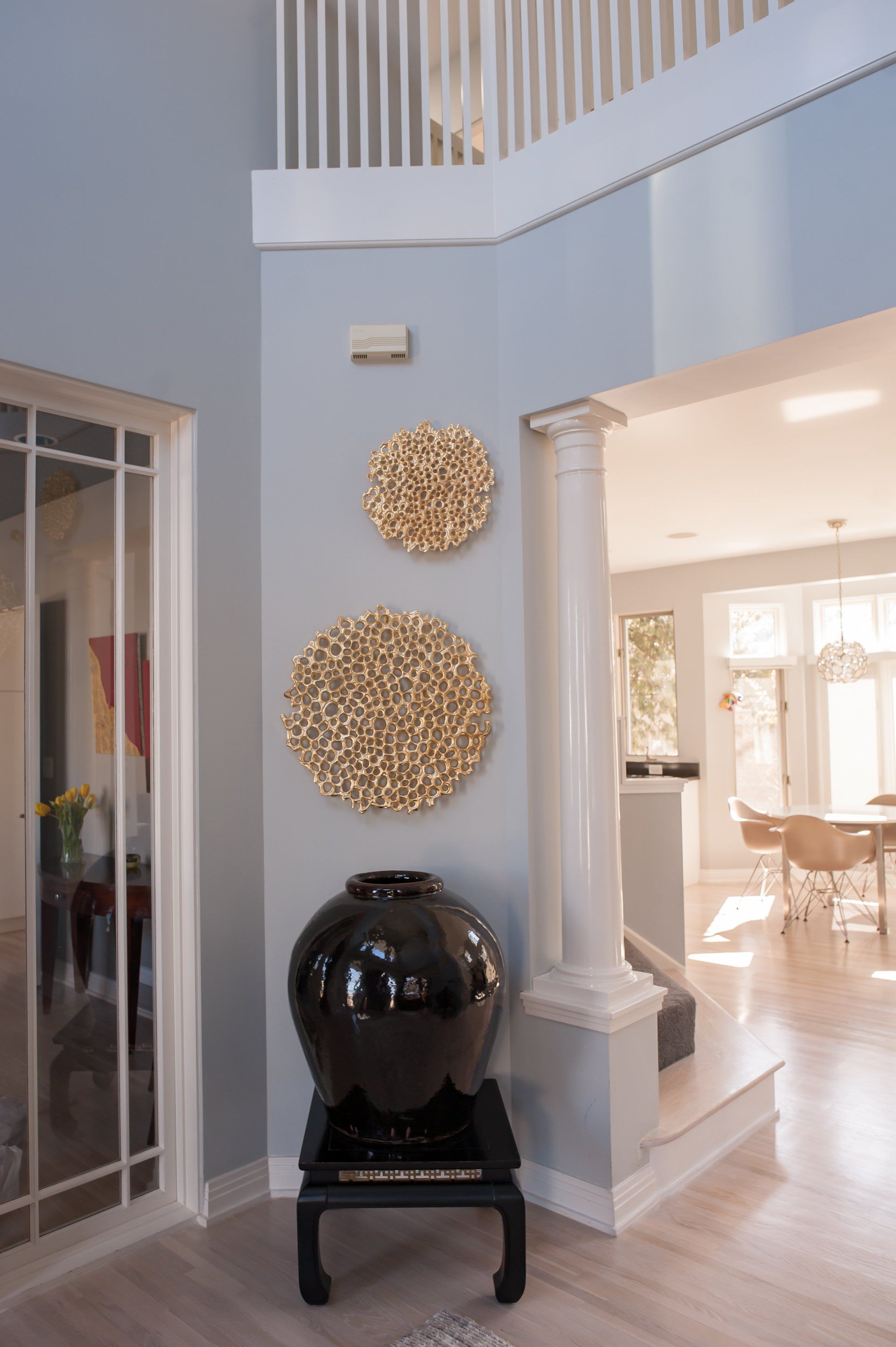 There is a vase on a table in the middle of the room.