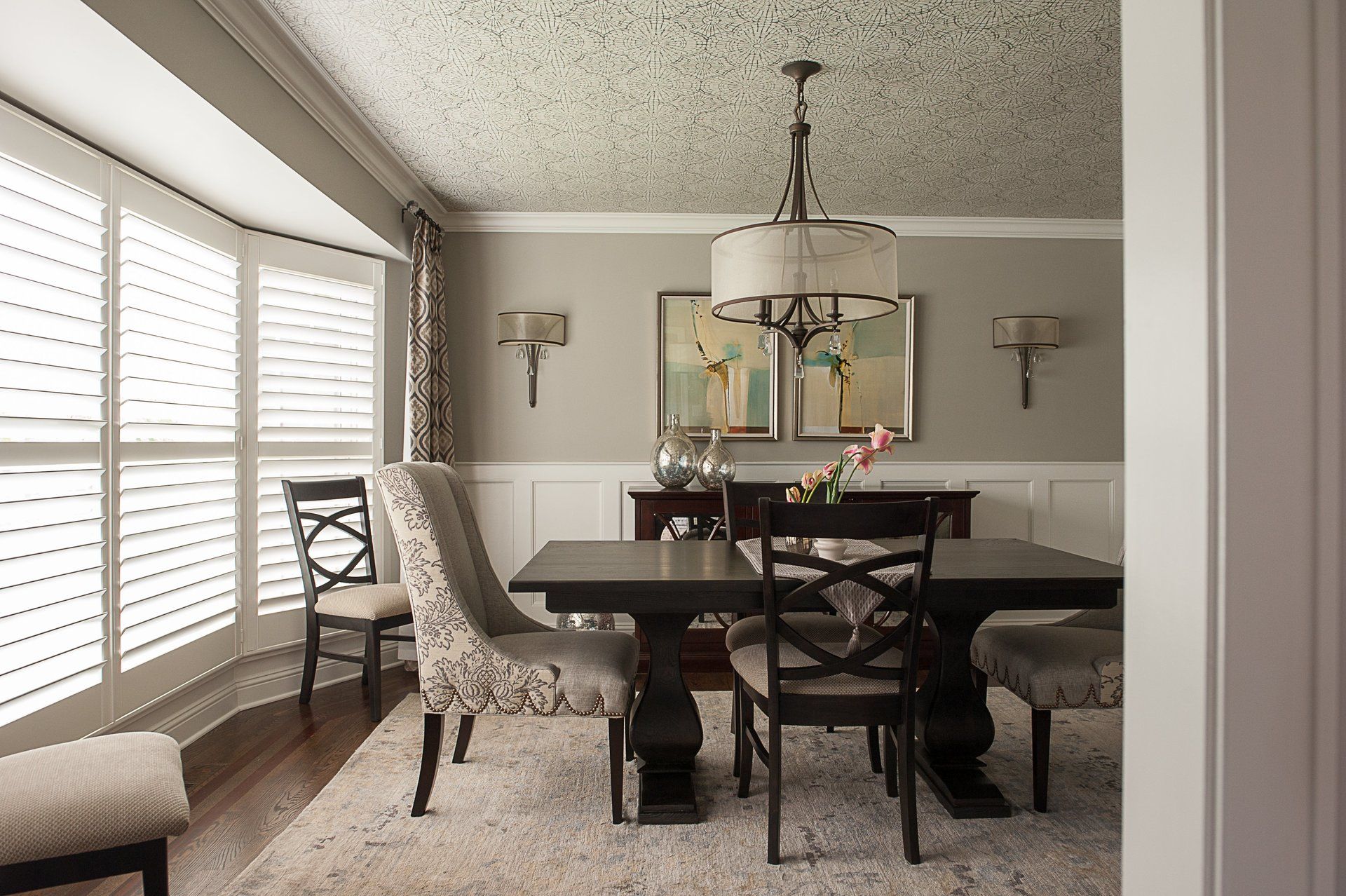 A dining room with a table and chairs and a chandelier