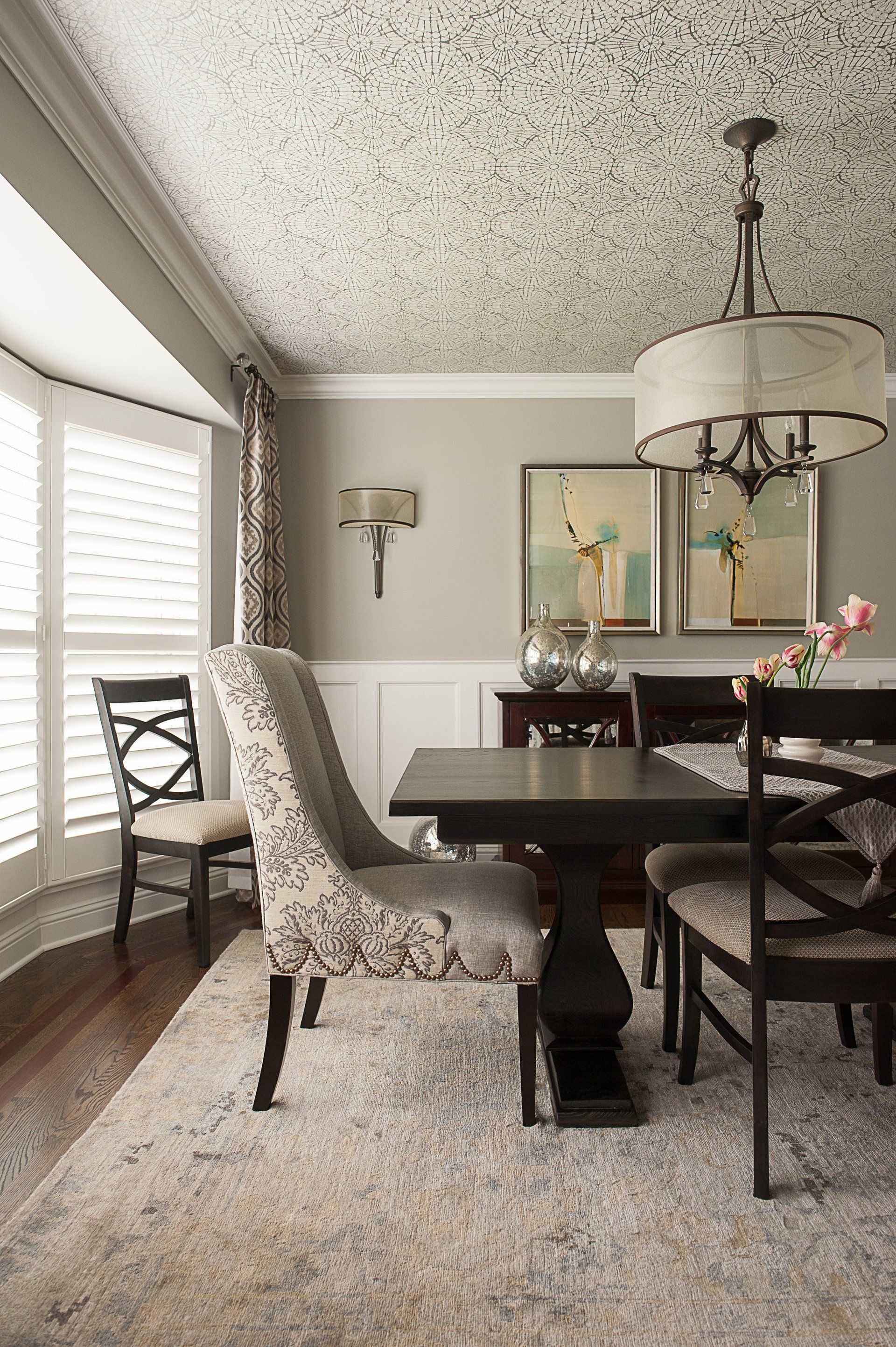 A dining room with a table and chairs and a chandelier.