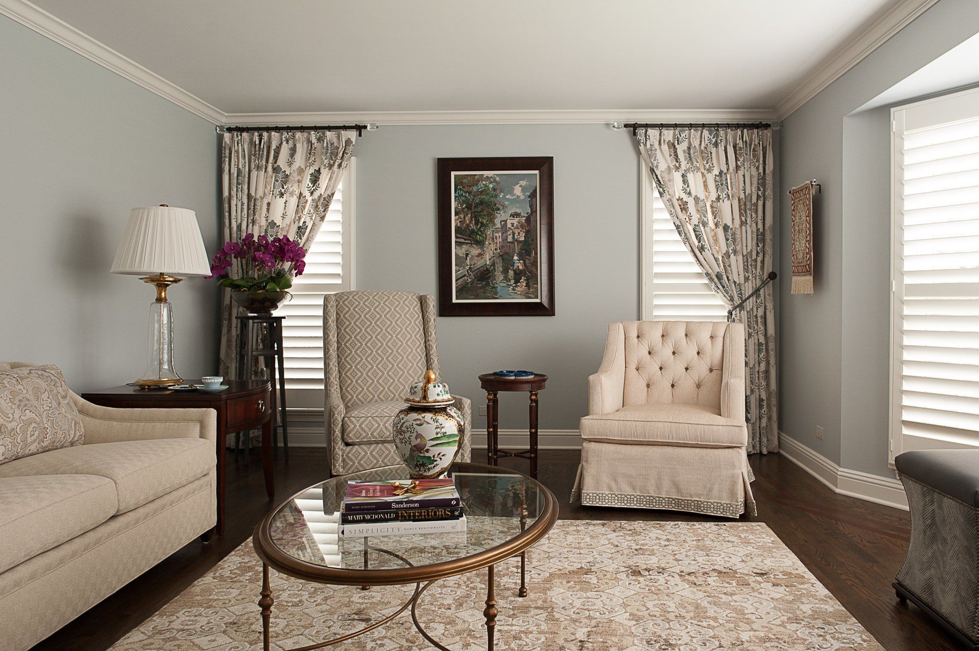 A living room with a couch two chairs and a coffee table