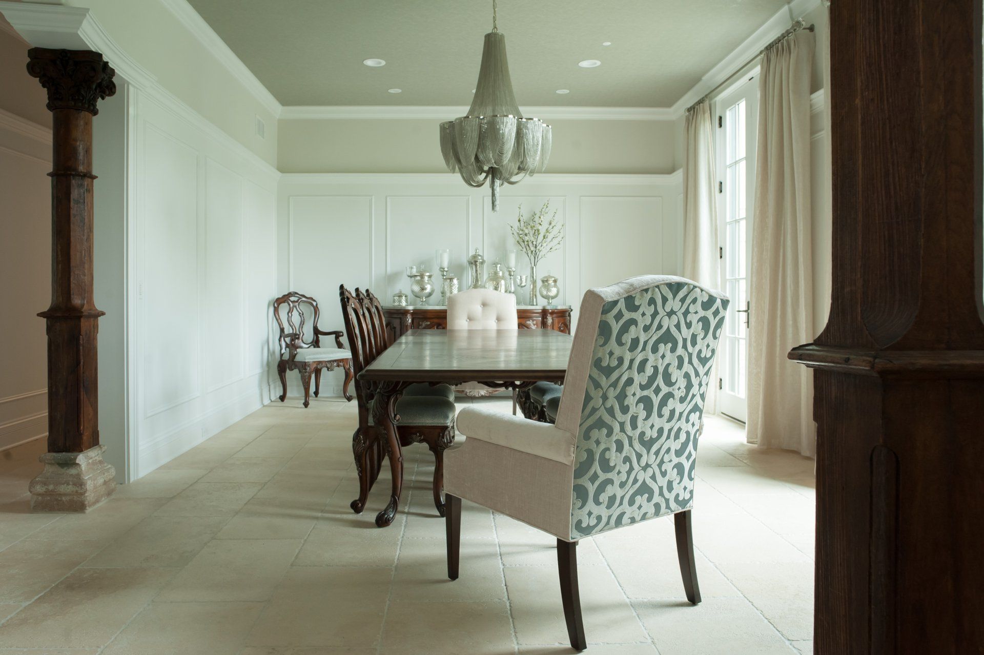 A dining room with a long table and chairs