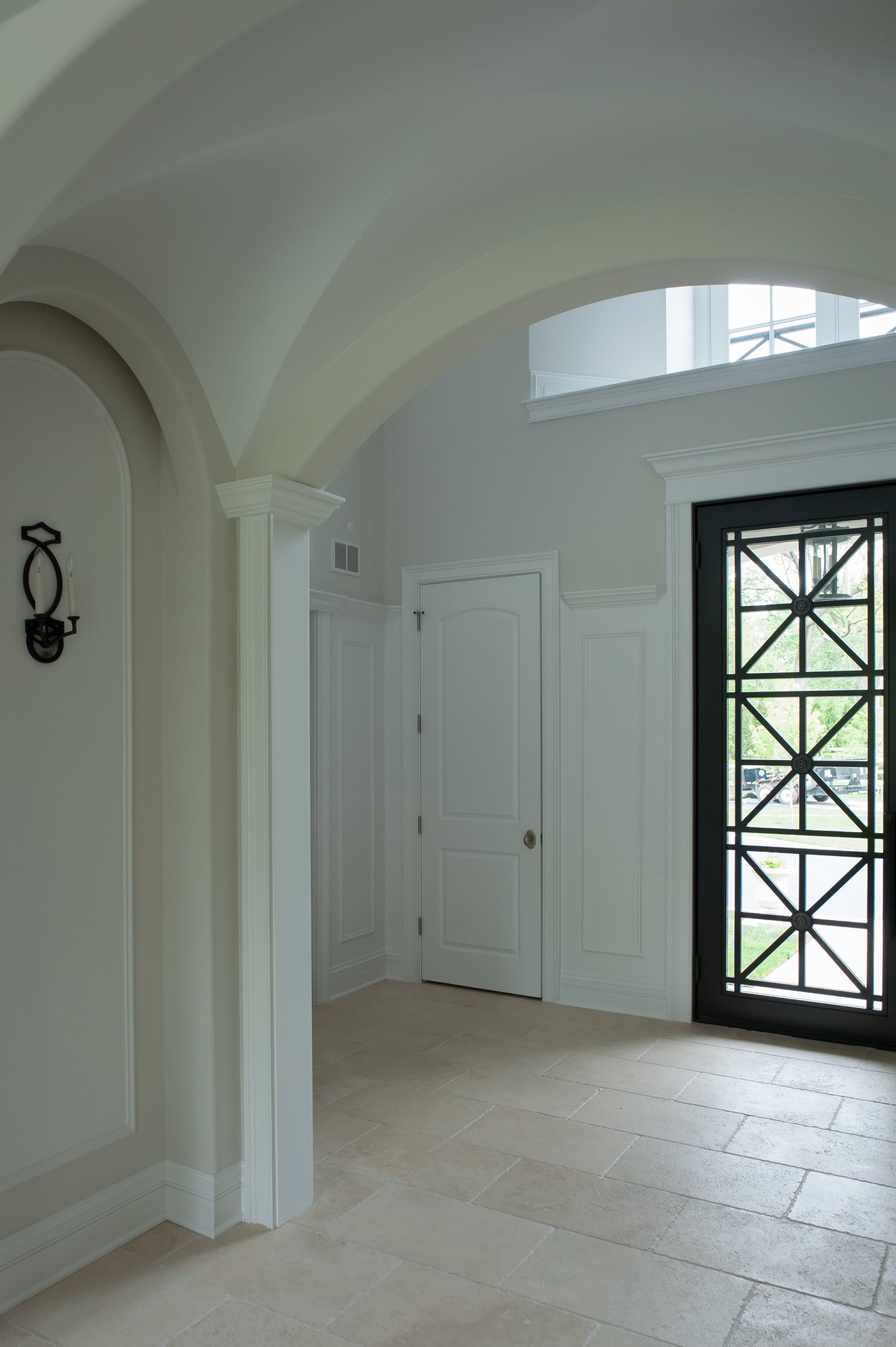 An empty room with white walls and a black door