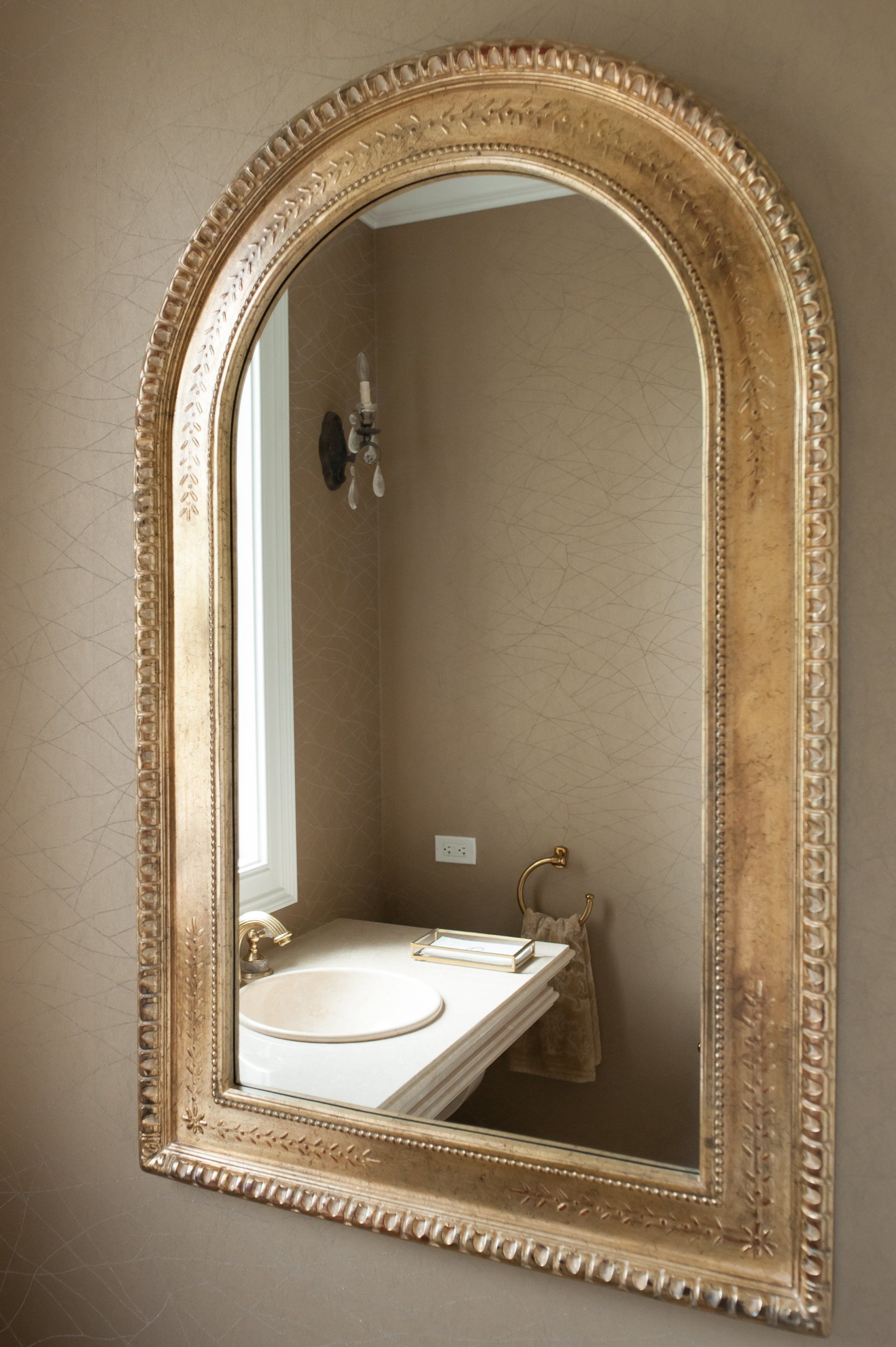 A bathroom with a large mirror and a sink