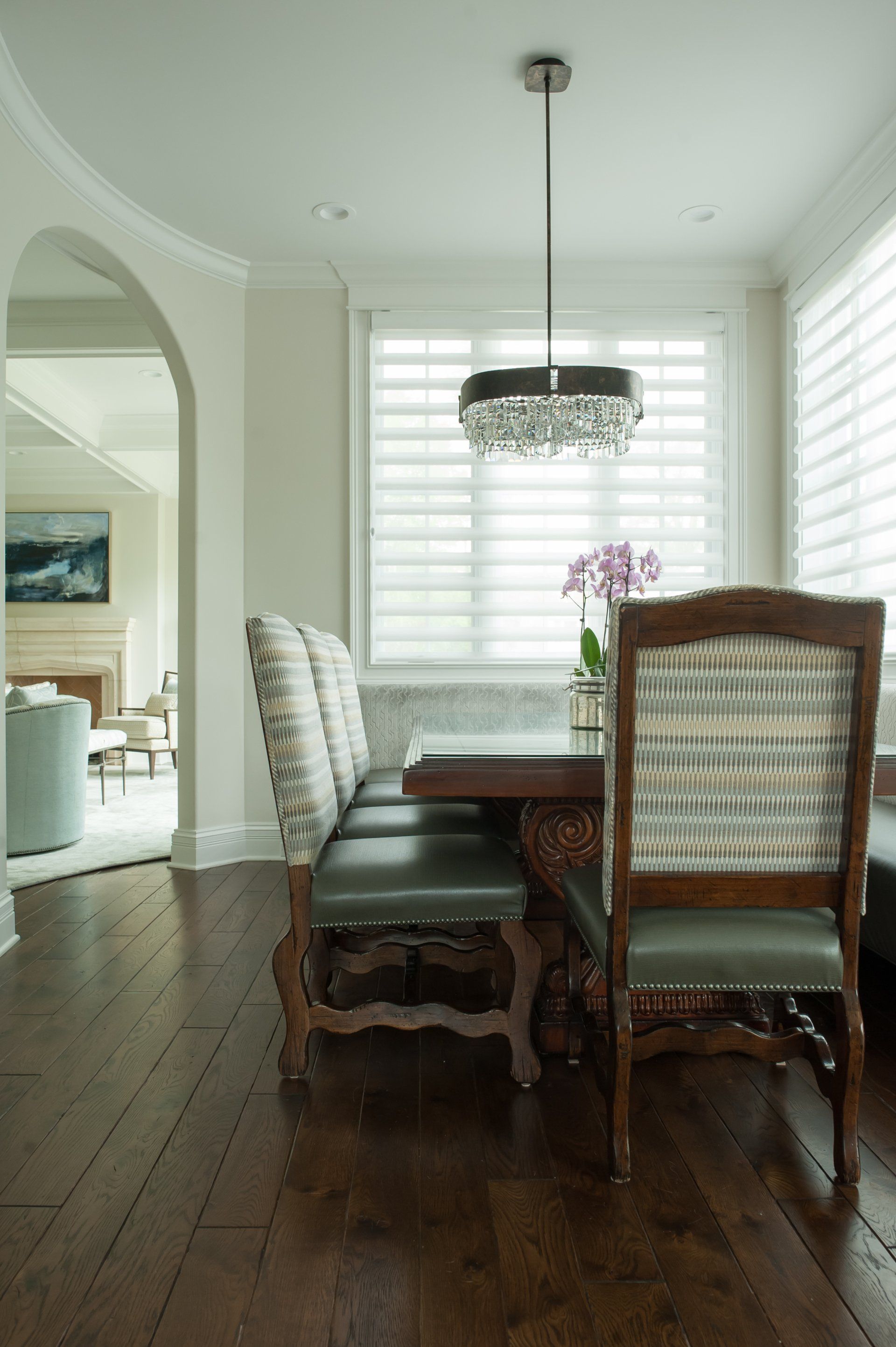 A dining room with a table and chairs and a bench.