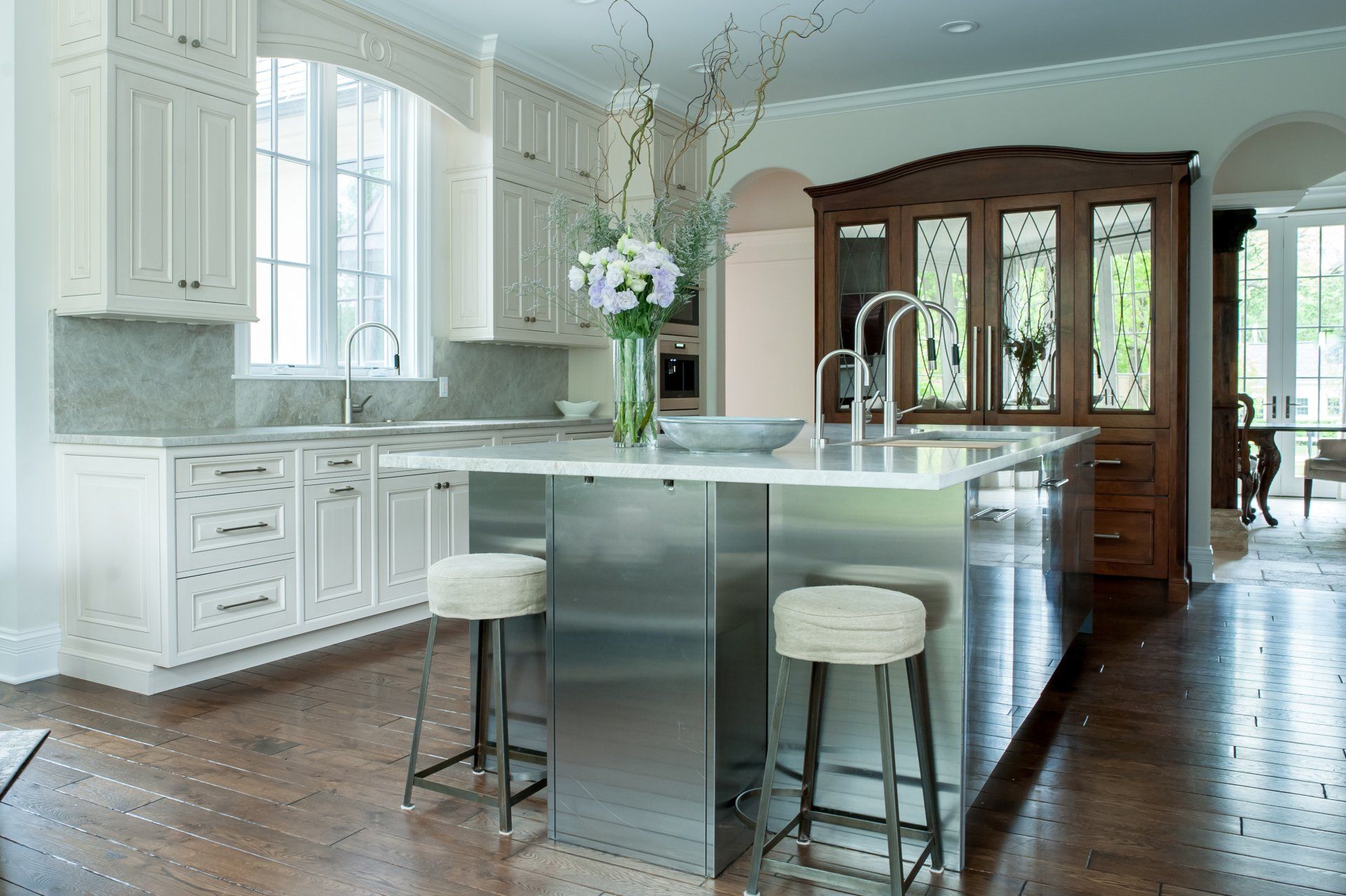 A kitchen with stainless steel appliances and white cabinets