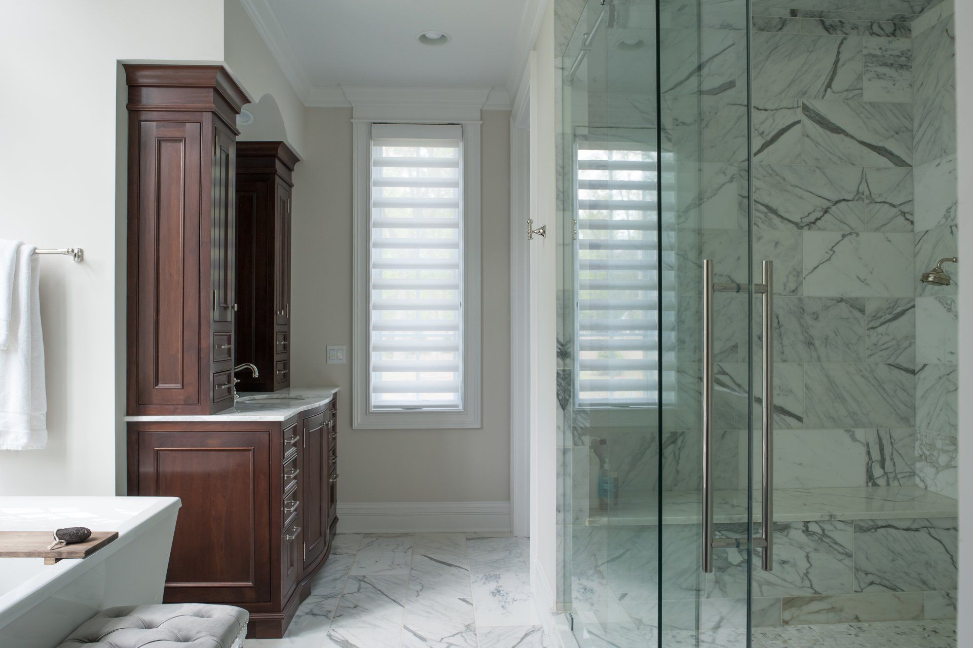 A bathroom with a walk in shower and two sinks