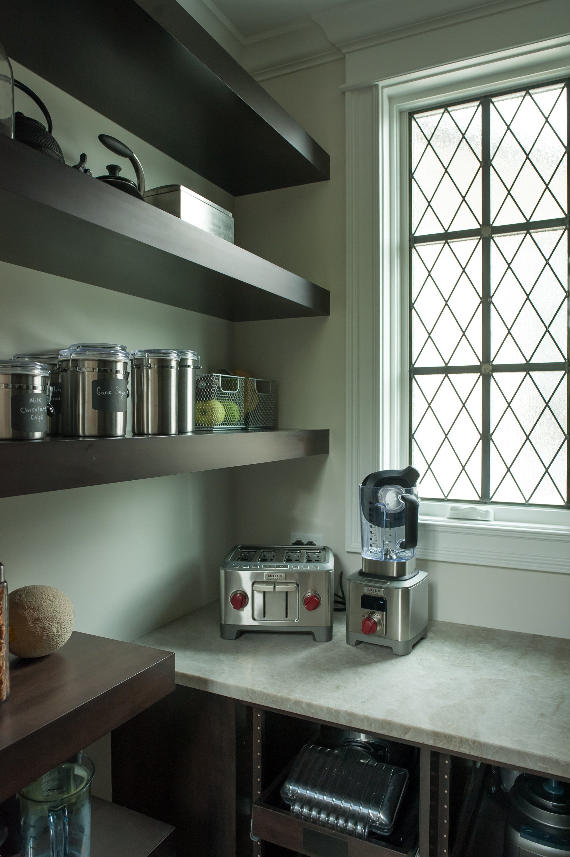 A kitchen with a toaster and blender on the counter
