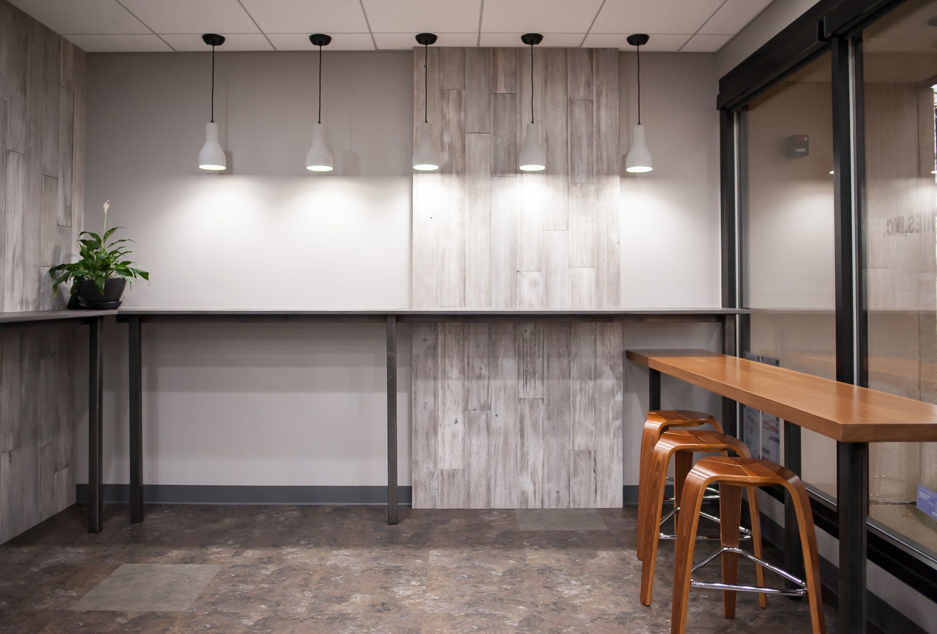 A room with a table and stools in it.