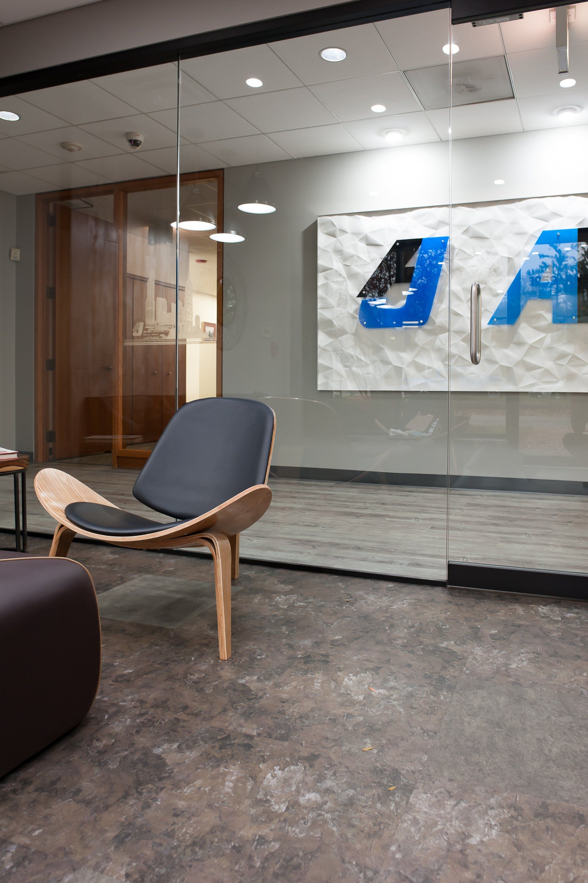 A chair is sitting in a room next to a glass wall.