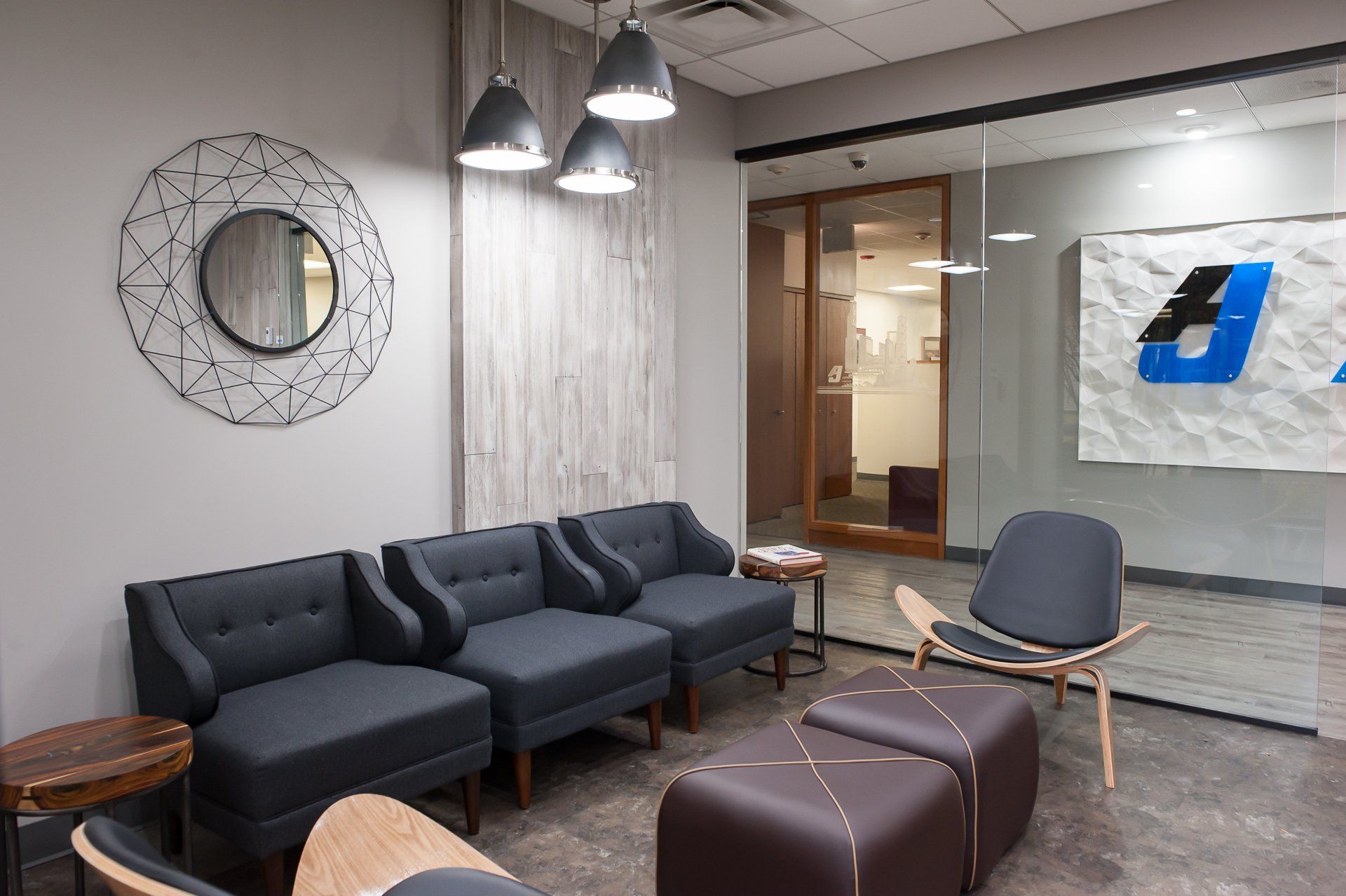 A waiting room with a lot of chairs and a mirror.