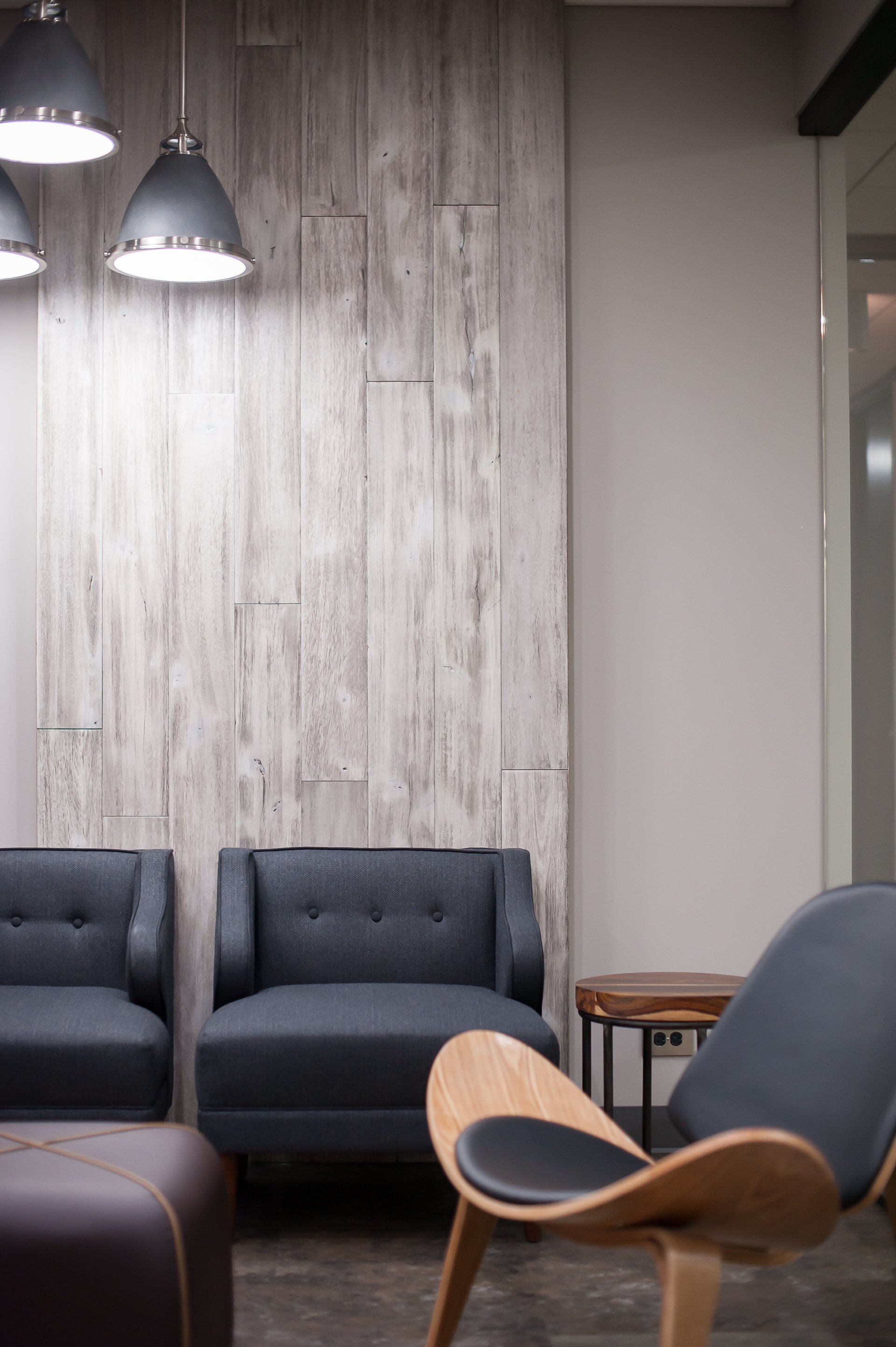 A living room with a couch , chair and ottoman
