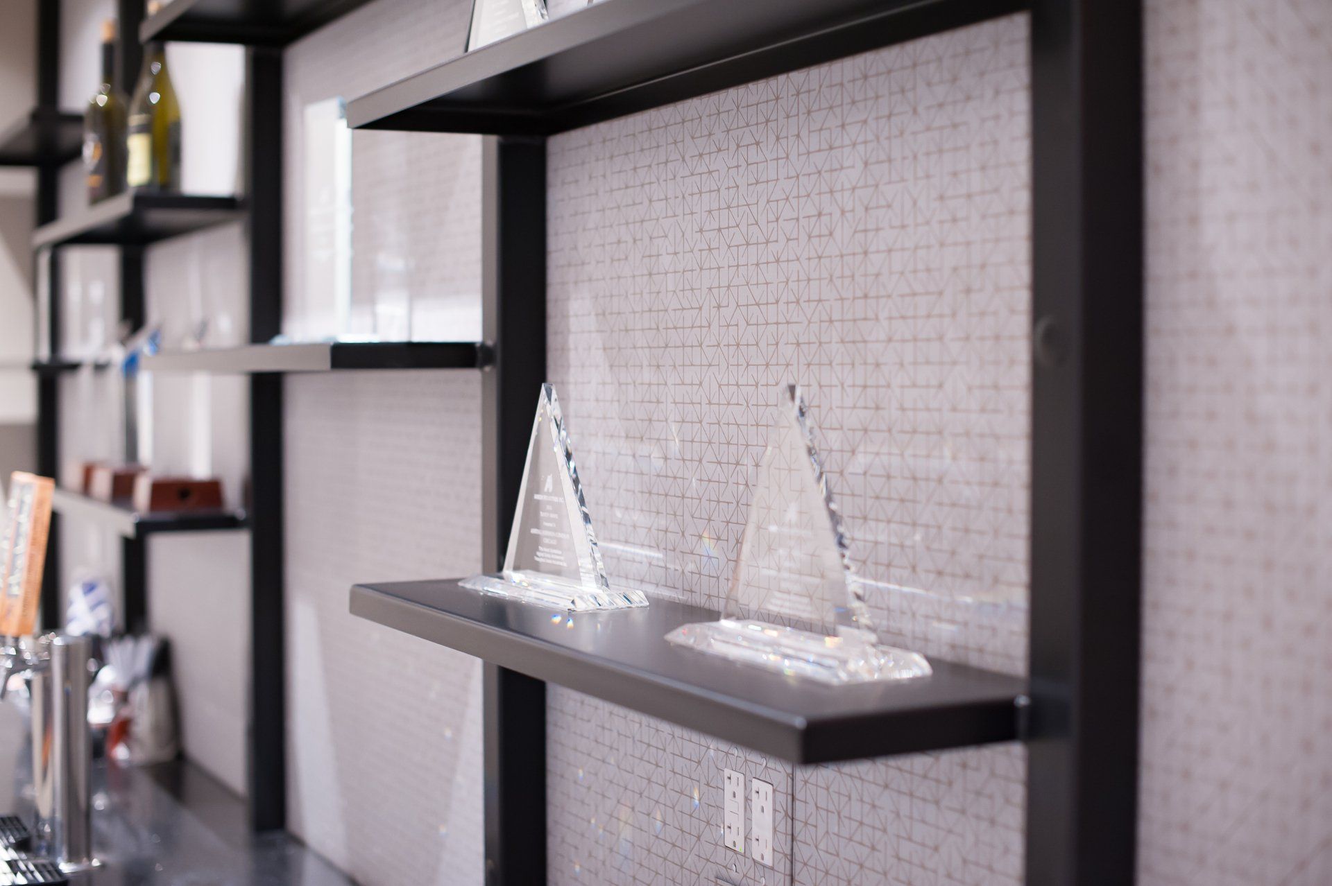 A shelf with two sailboats on it in a room.