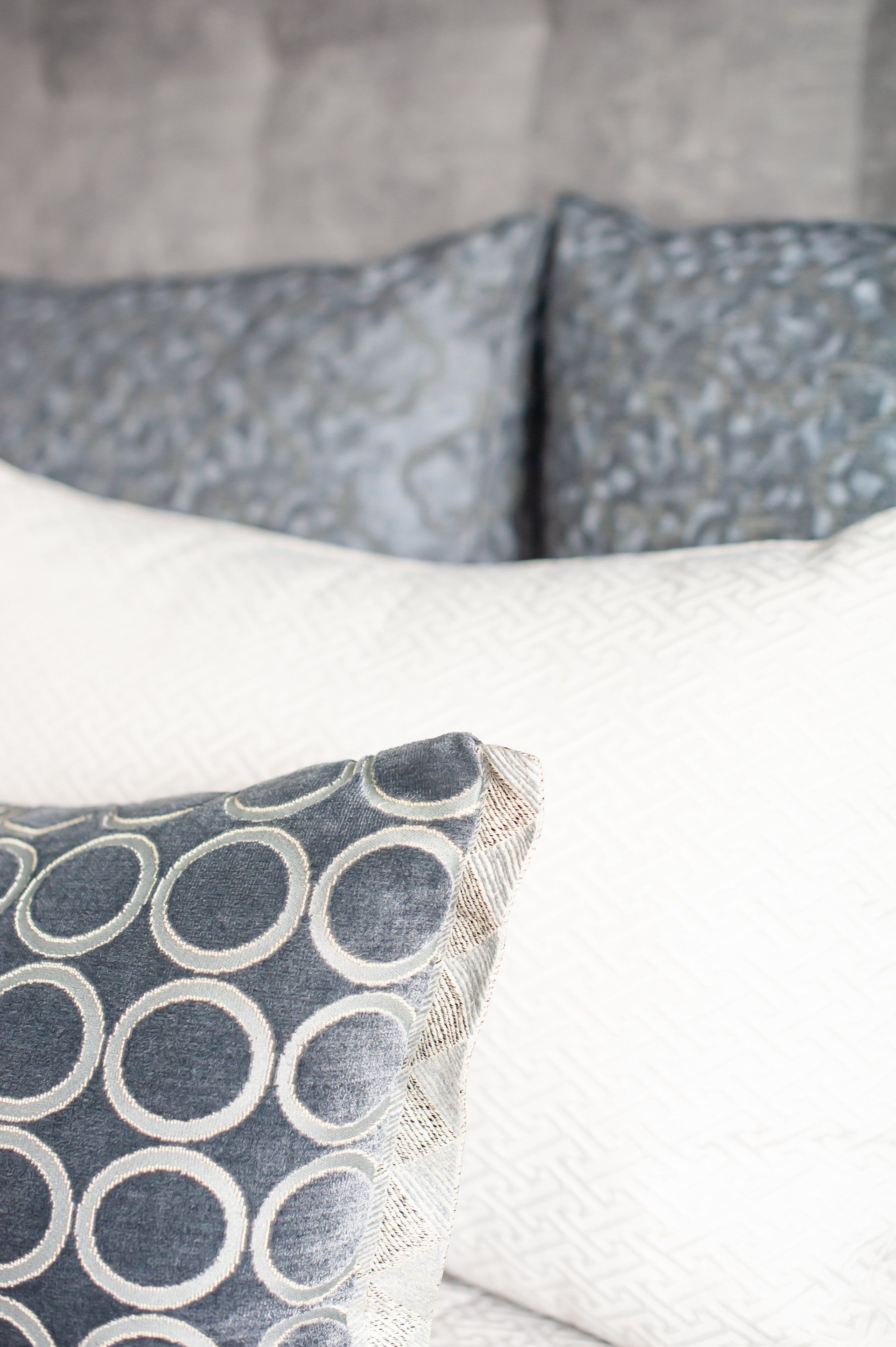 A close up of two pillows on a bed.