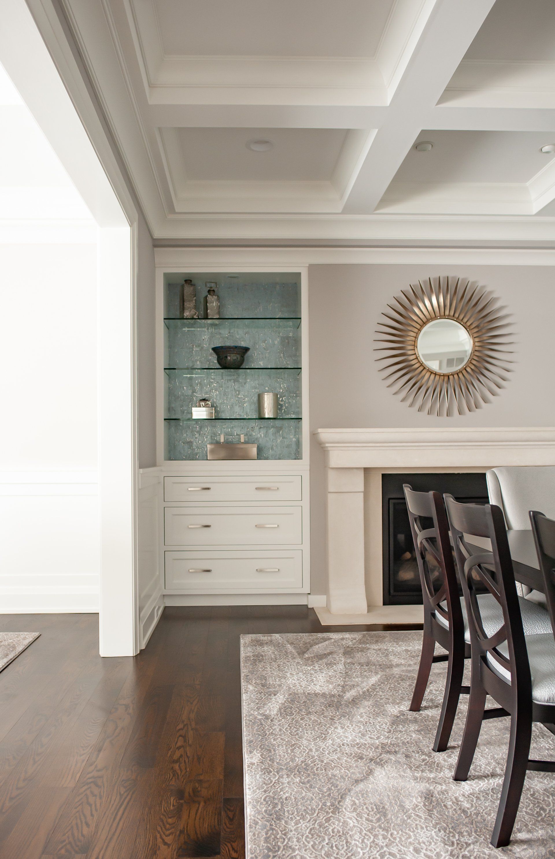 A living room with a fireplace and a mirror on the wall.