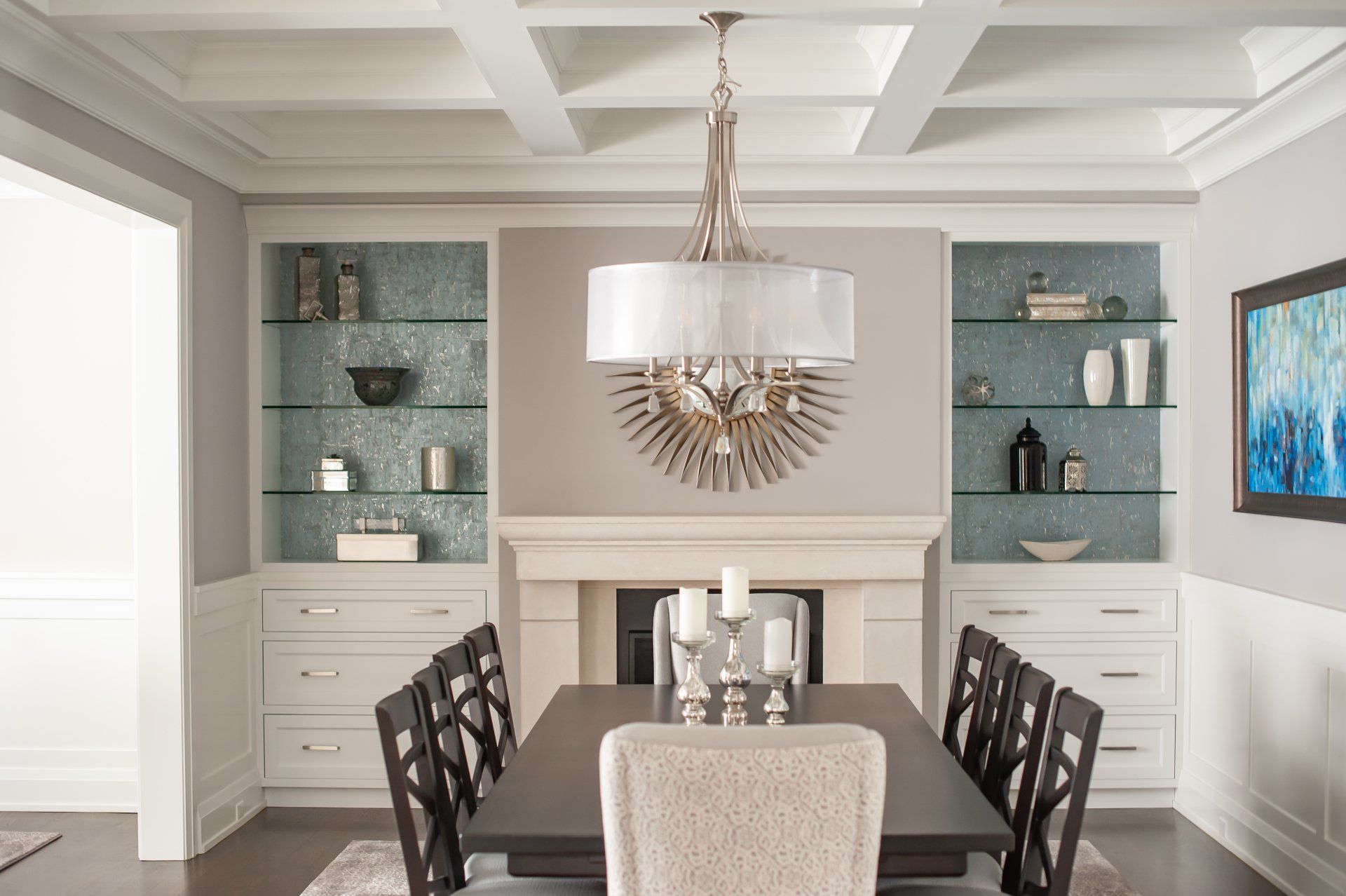 A dining room with a table and chairs and a fireplace.