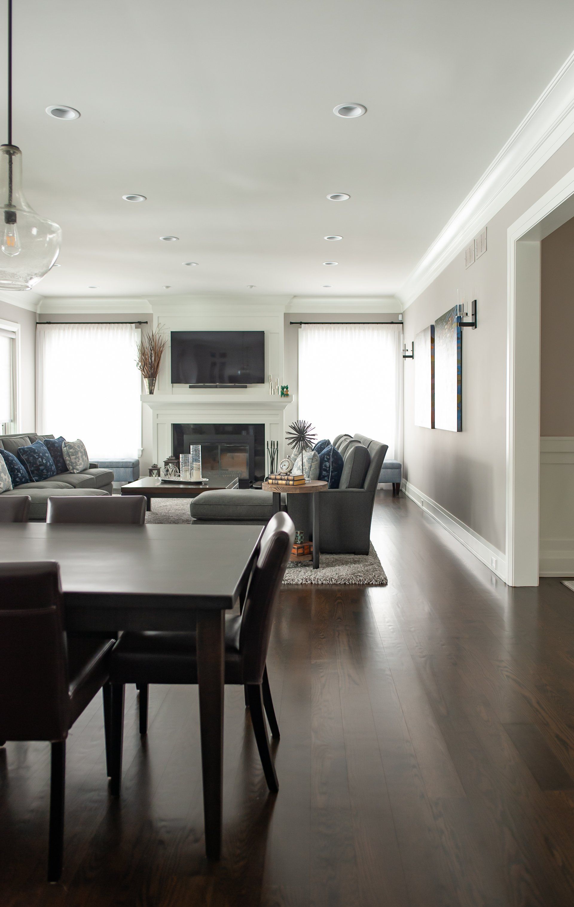A living room with a table and chairs and a fireplace