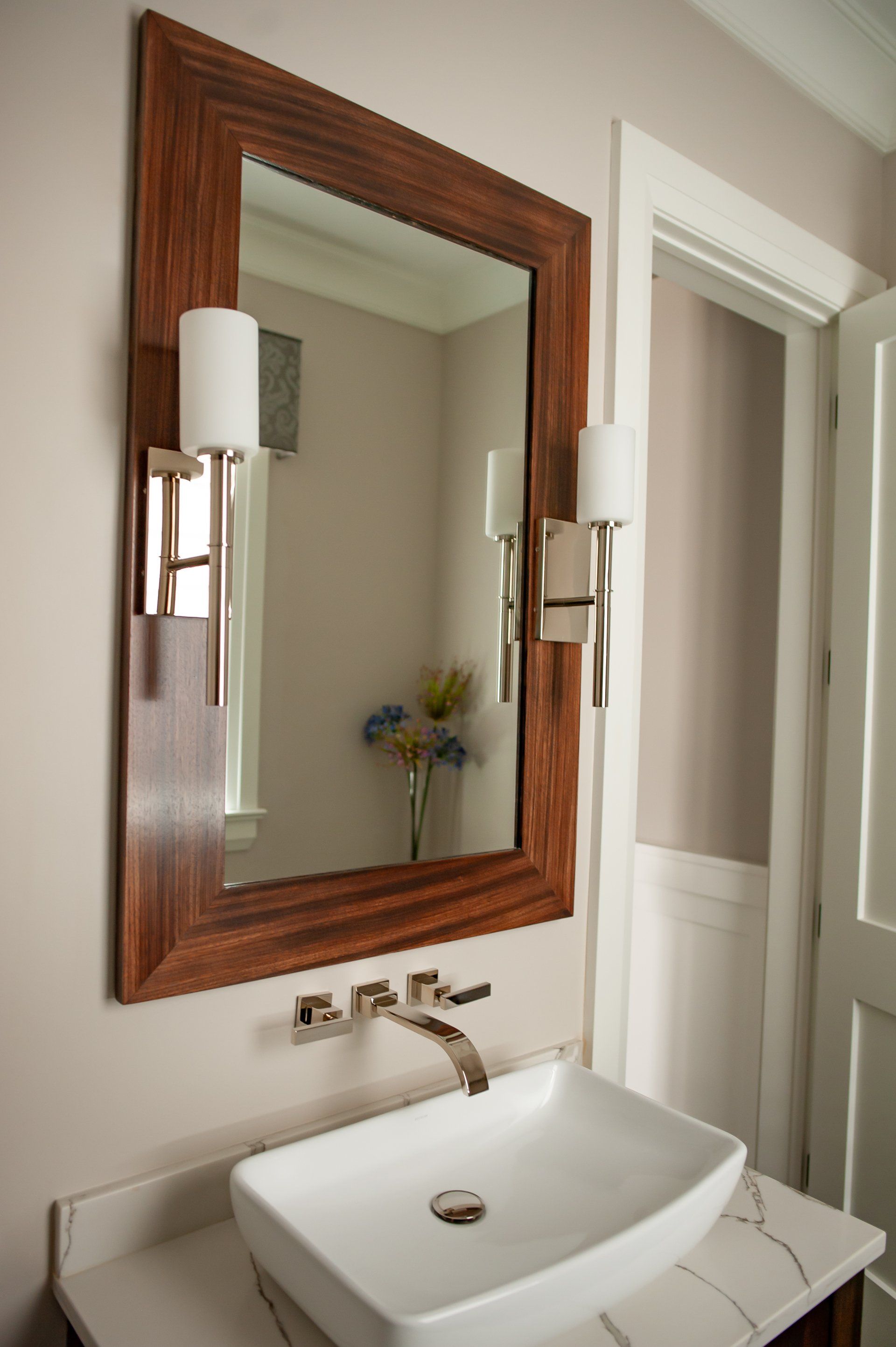 A bathroom with a sink and a mirror on the wall.