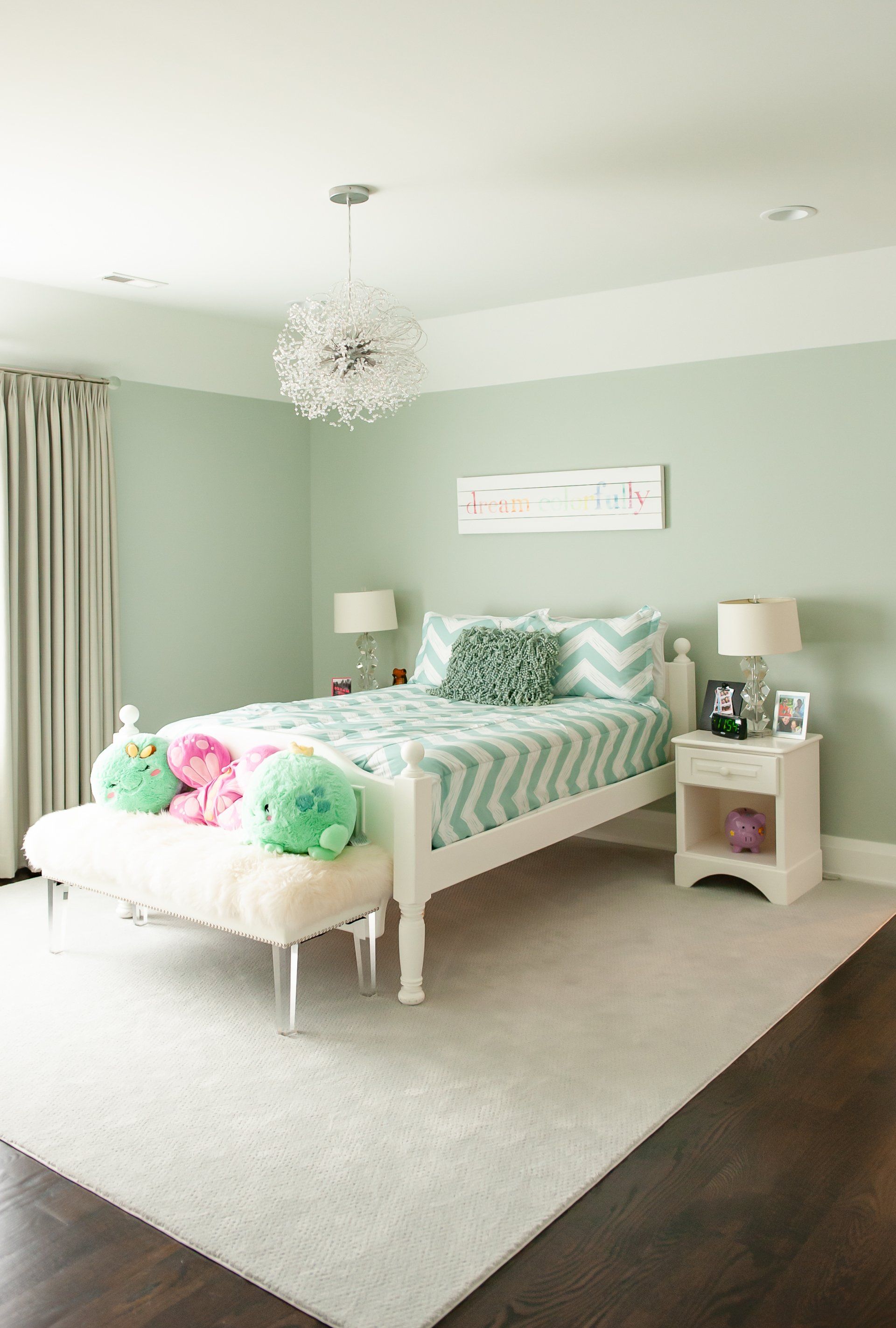 A bedroom with a bed , nightstands , and a bench.