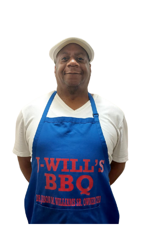 A man wearing a blue apron that says j will 's bbq