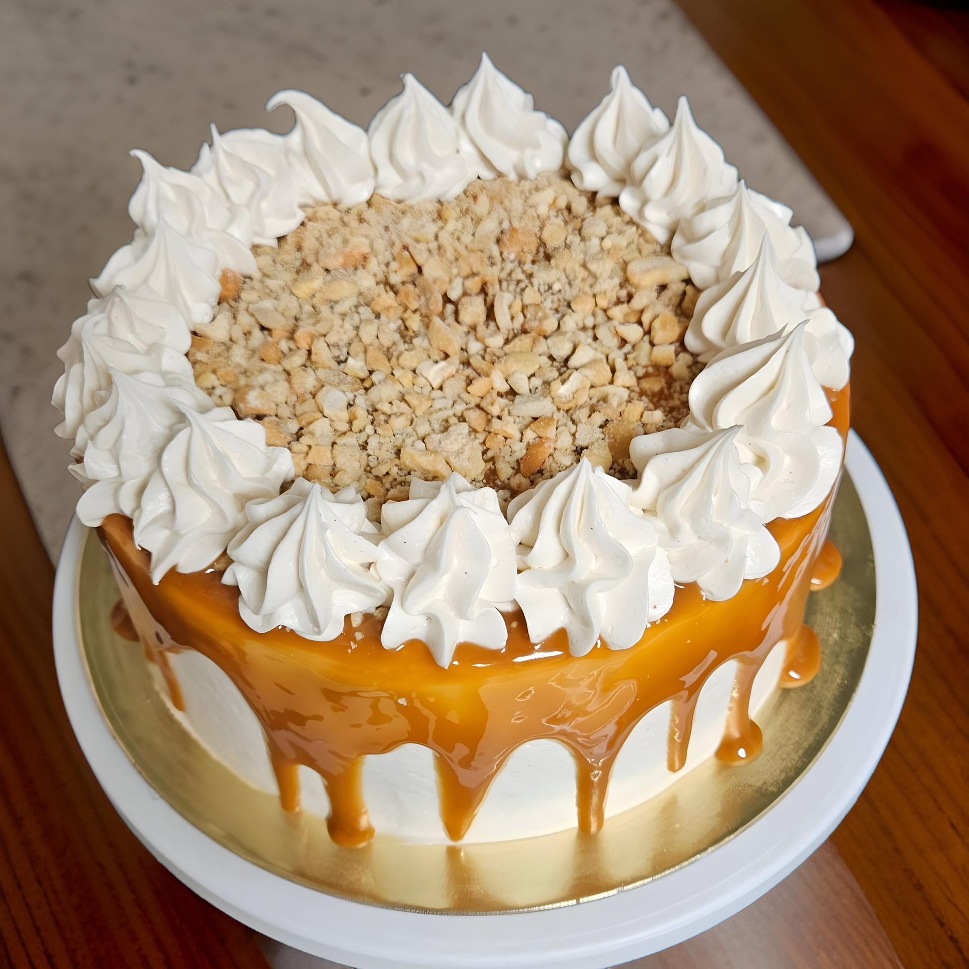 A cake with whipped cream and nuts on top of it