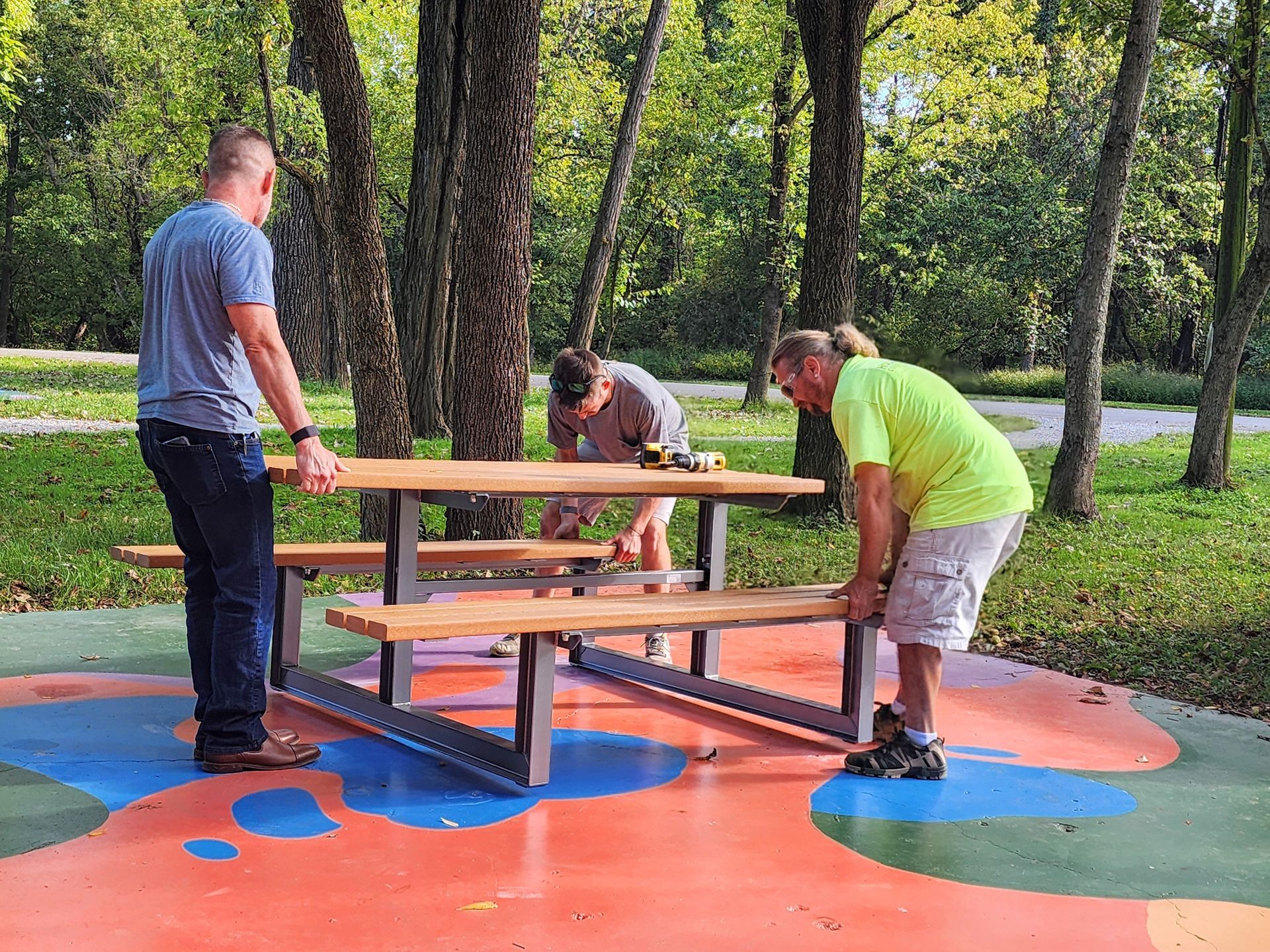 Workers installing picnic tables in Buttonbush Trailhead.